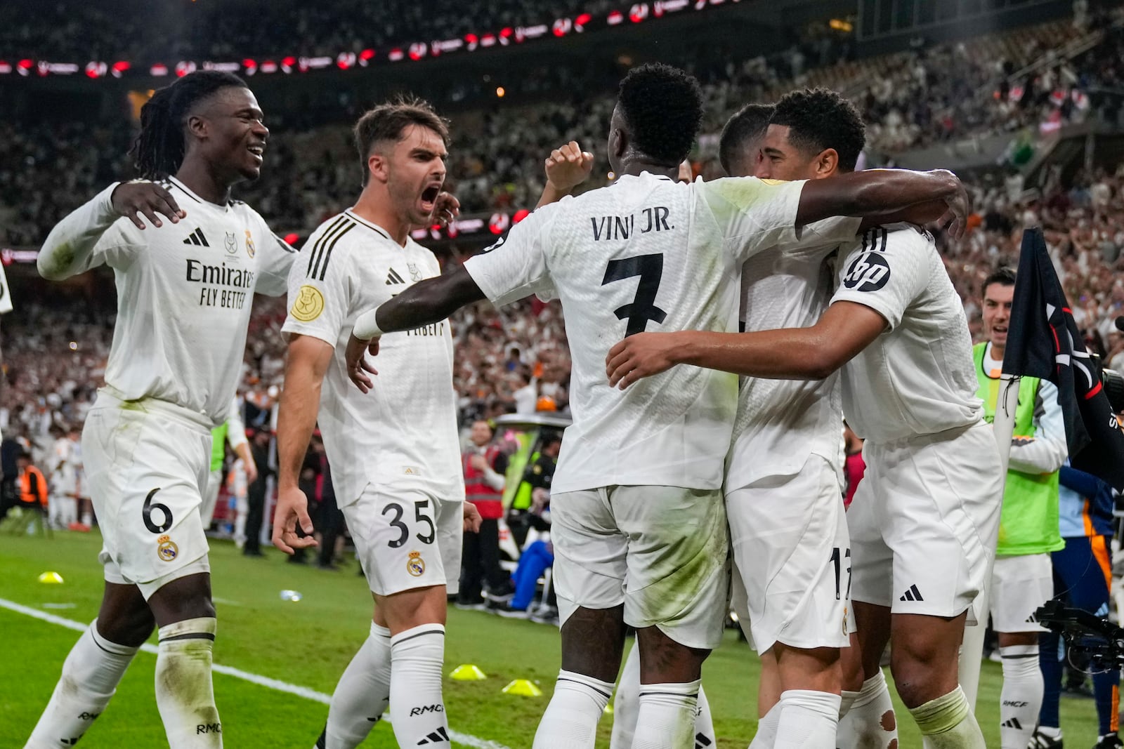 Real Madrid's Jude Bellingham, right, celebrates after scoring his side's opening goal during the Spanish Super Cup semifinal soccer match between Real Madrid and Mallorca at the King Abdullah Stadium in Jeddah, Saudi Arabia, Thursday, Jan. 9, 2025. (AP Photo/Altaf Qadri)