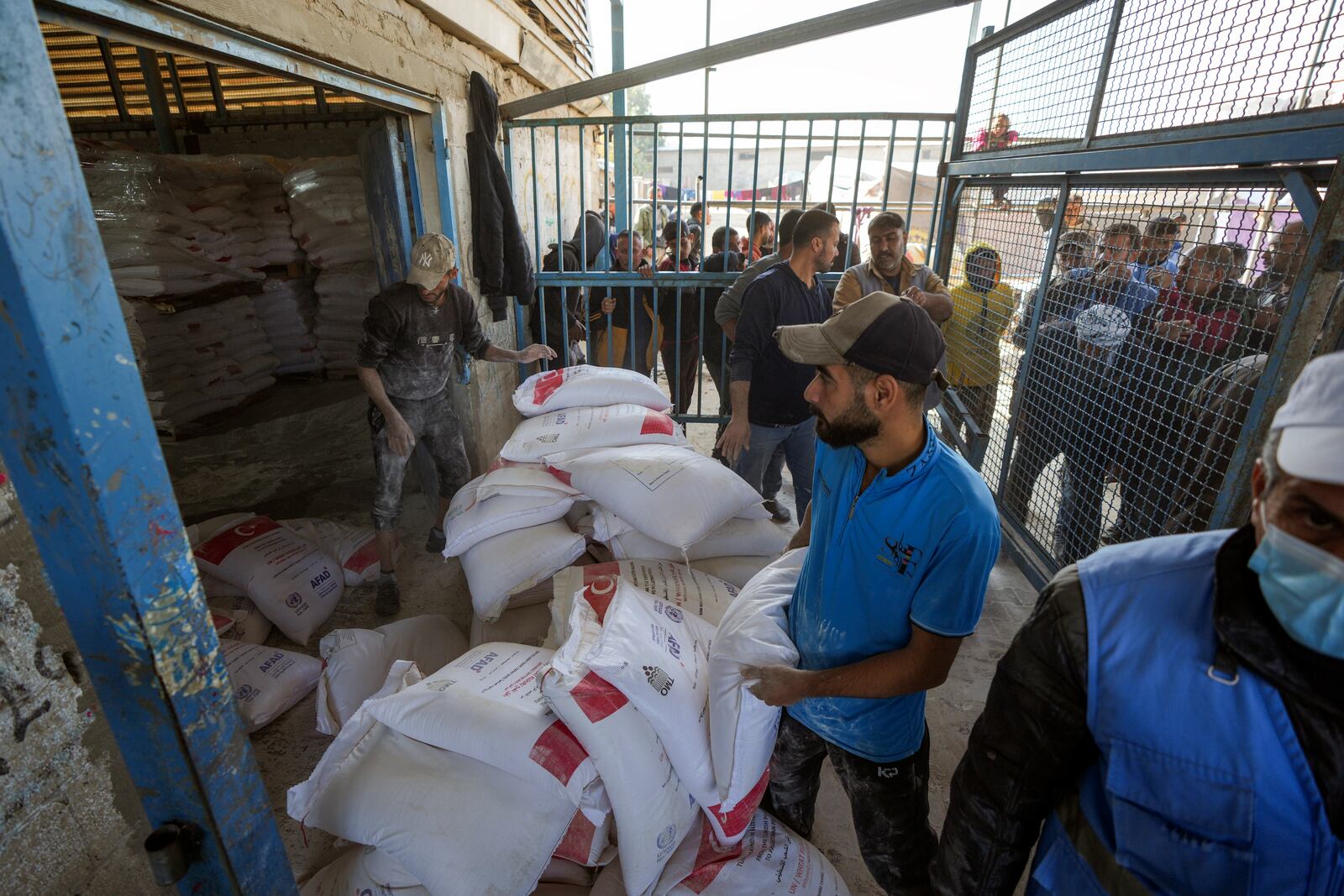 Donated flour is distributed to Palestinians at a UNRWA center in the Nuseirat refugee camp, Gaza Strip, Tuesday Dec. 3, 2024.(AP Photo/Abdel Kareem Hana)