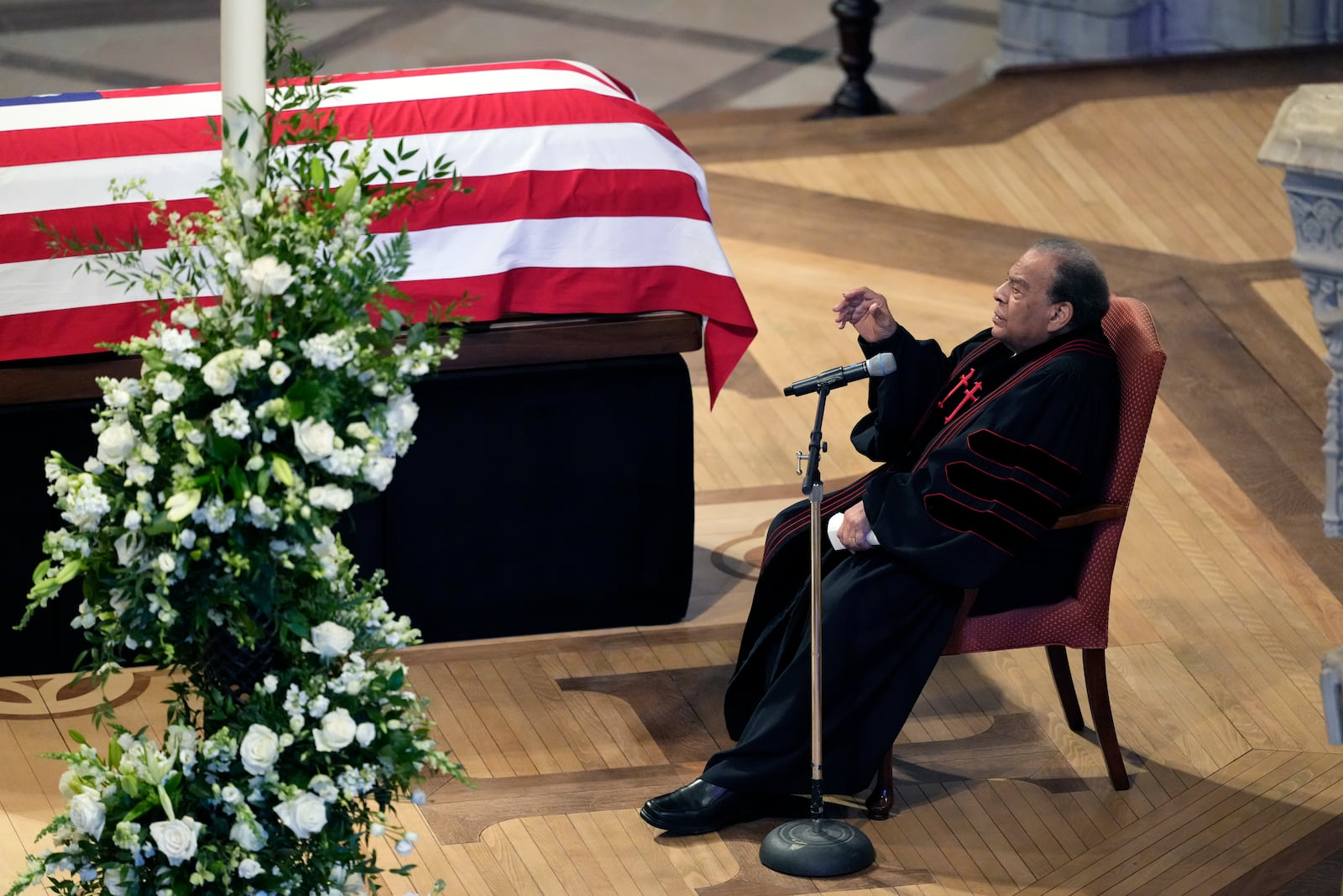 The Honorable Andrew Young speaks a Homily next to the flag-draped casket of former President Jimmy Carter, during a state funeral at Washington National Cathedral, Thursday, Jan. 9, 2025, in Washington. (AP Photo/Ben Curtis)