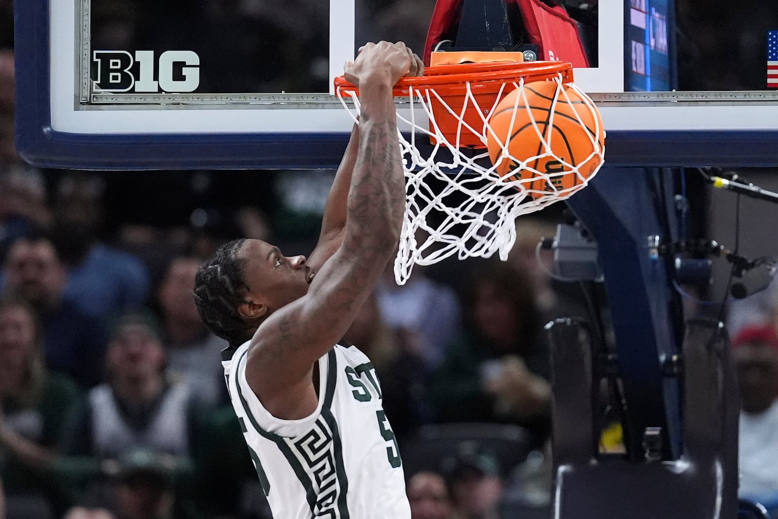 Michigan State forward Coen Carr (55) dunks against Wisconsin during the second half of an NCAA college basketball game in the semifinals of the Big Ten Conference tournament in Indianapolis, Saturday, March 15, 2025. (AP Photo/Michael Conroy)