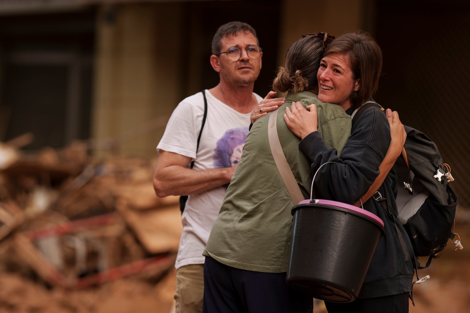 People embrace each other in an area affected by floods in Valencia, Spain, Saturday, Nov. 2, 2024. (AP Photo/Manu Fernandez)