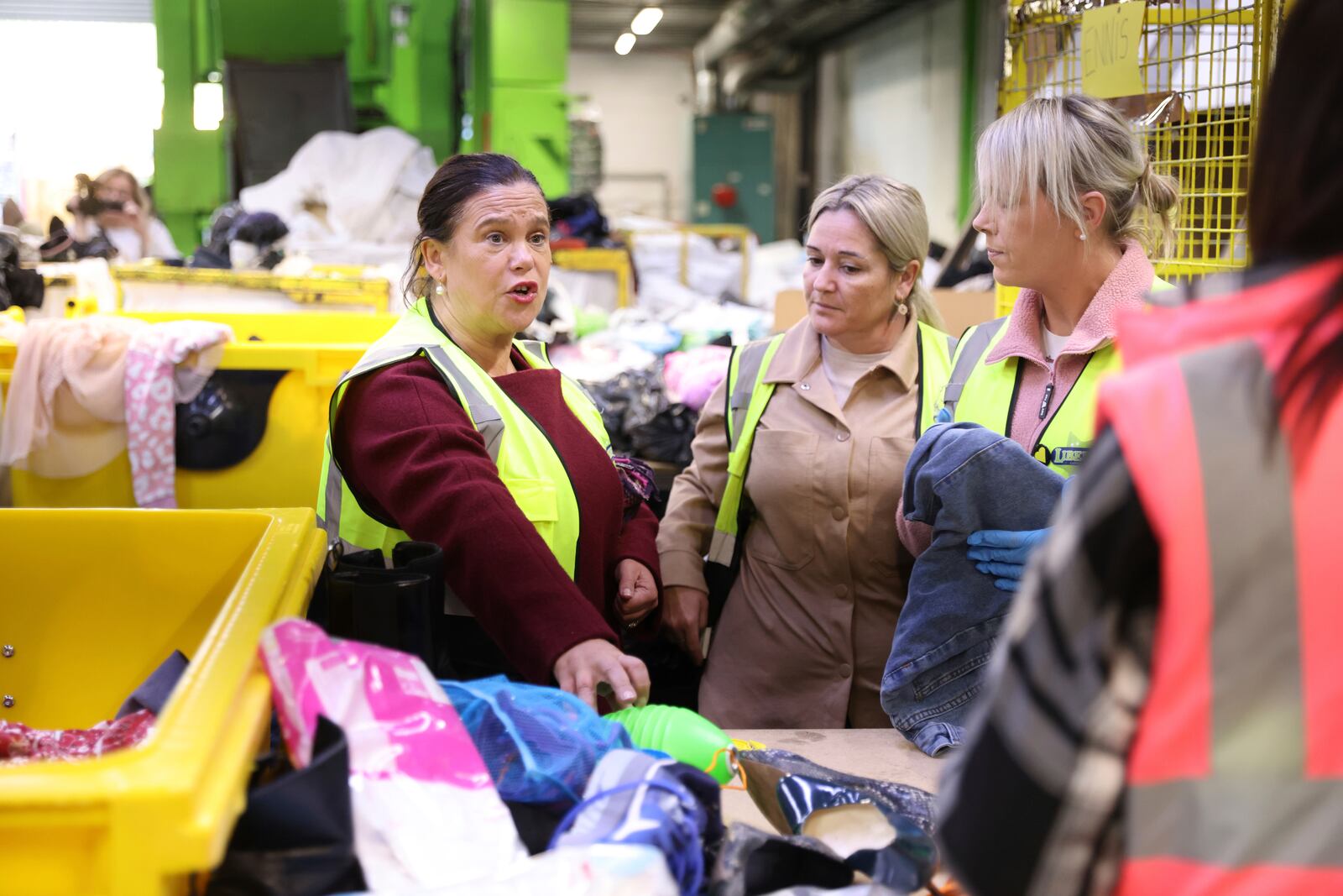 Sinn Fein leader Mary Lou McDonald, left, meets workers during a visit to Liberty Recycling in Dublin, Ireland, Tuesday, Nov. 26, 2024, ahead of Ireland's election on Friday. (AP Photo/Peter Morrison)