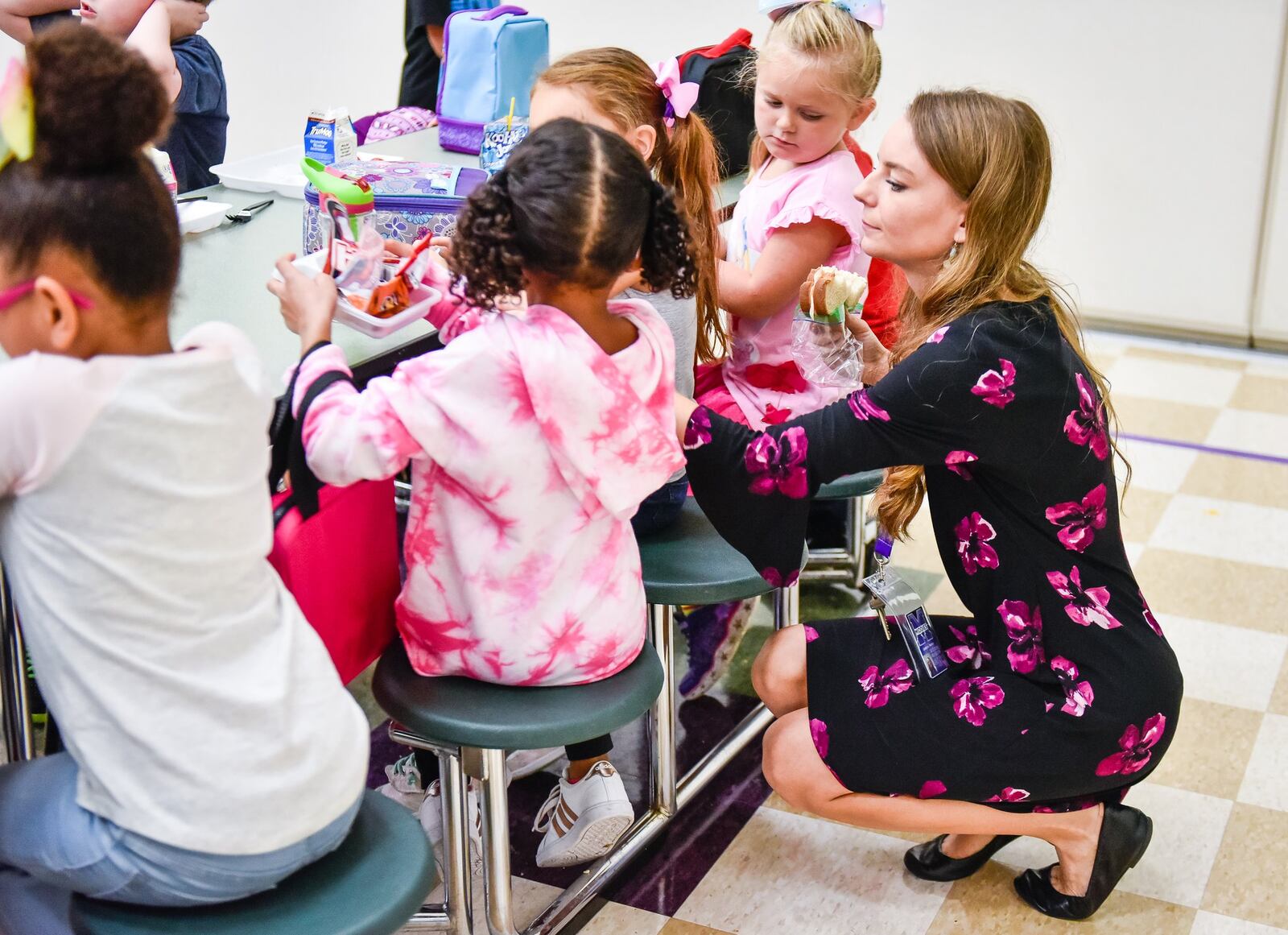 Carrie Parsons eats her sandwich as she helps her students during lunch. 