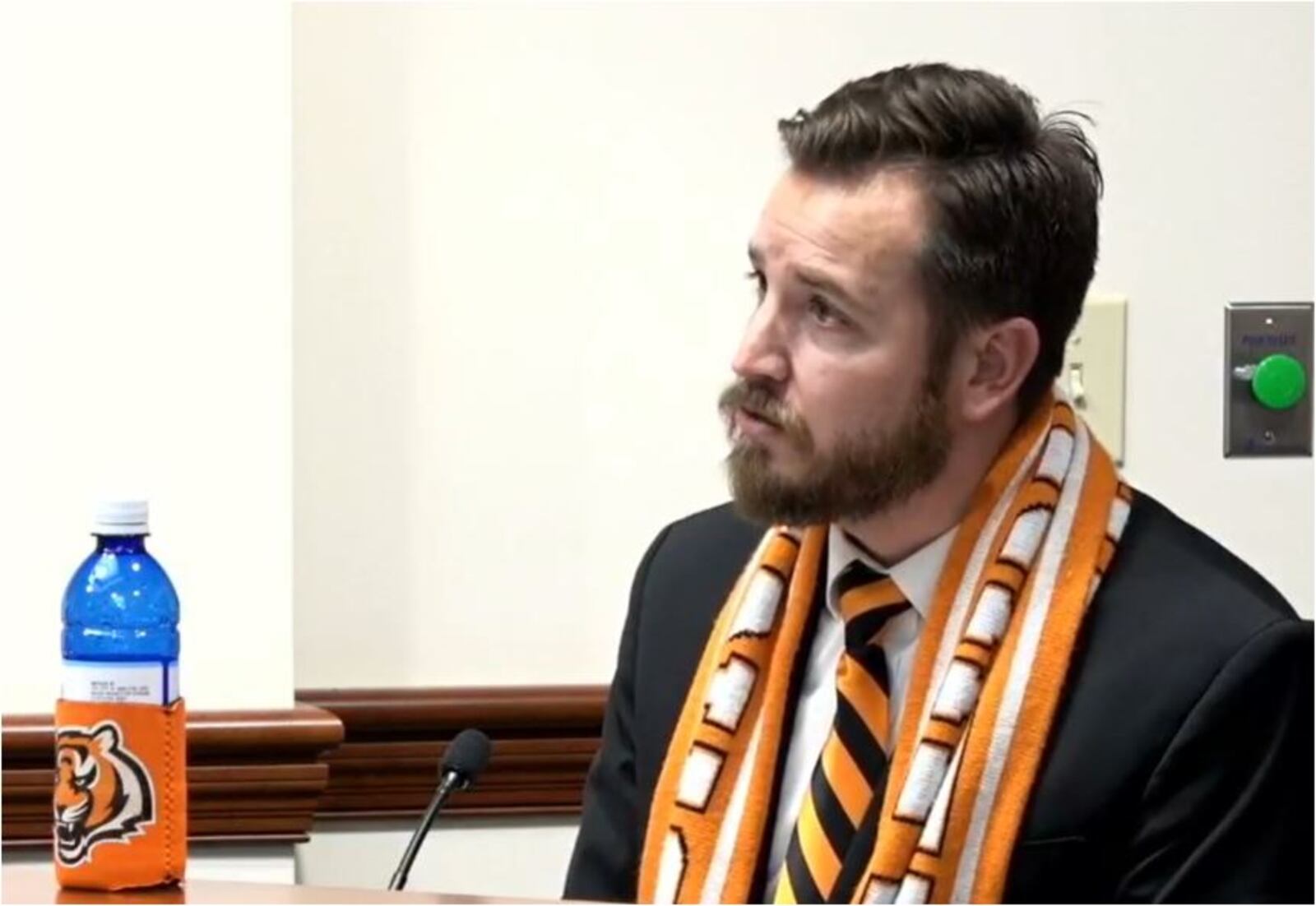 Hamilton Vice Mayor wore his stripes at Wednesday's City Council meeting, with a team scarf, striped tie and a Bengals coozie around his bottle of Hamilton water. His house also is decorated in honor of the team. MIKE RUTLEDGE/STAFF