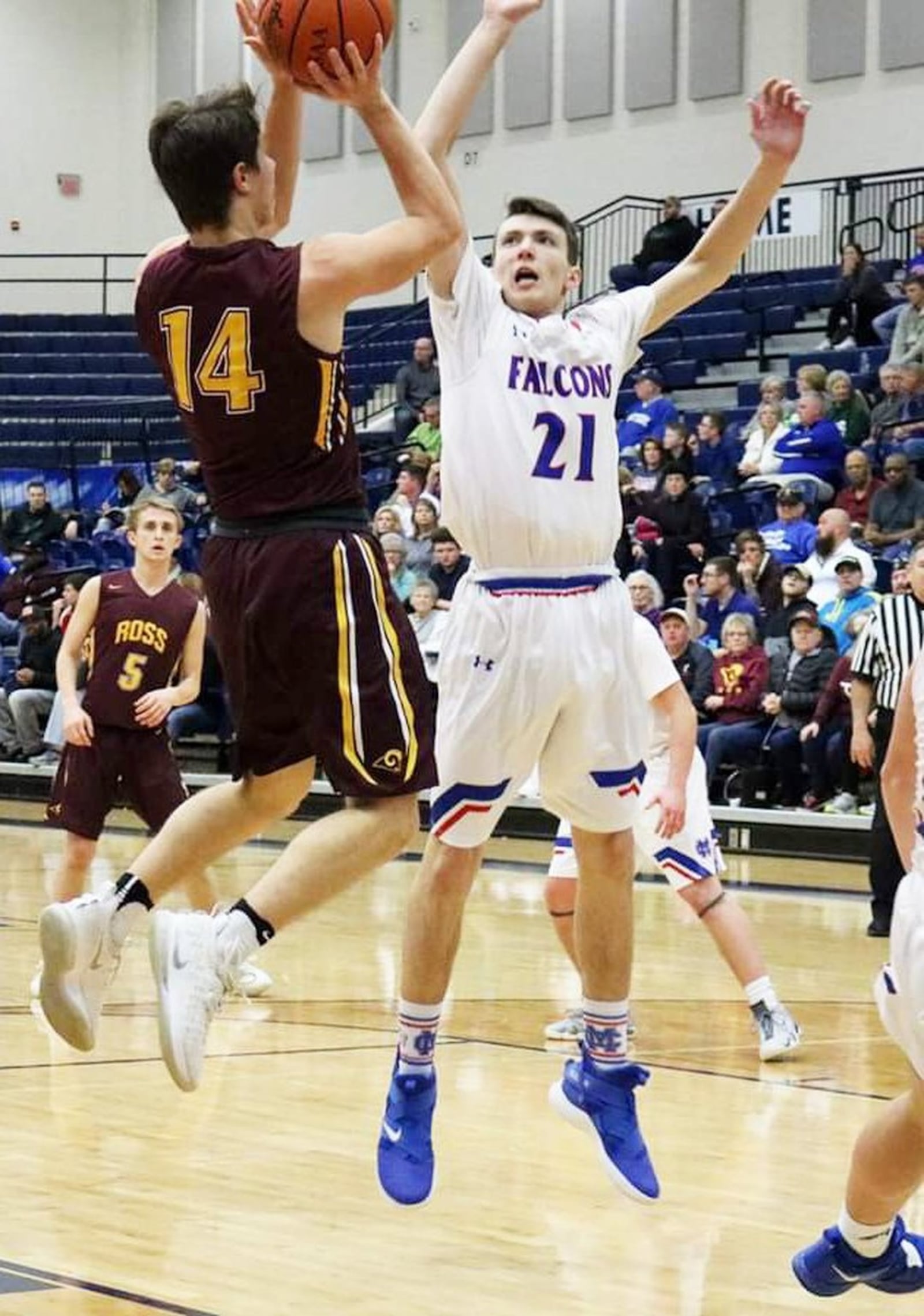 Cooper Shields (14) of Ross is defended by Clinton-Massie’s Nate Baker (21) during a Division II sectional basketball game Friday night at Fairmont’s Trent Arena in Kettering. Clinton-Massie won 61-54 in overtime. CONTRIBUTED PHOTO BY TERRI ADAMS