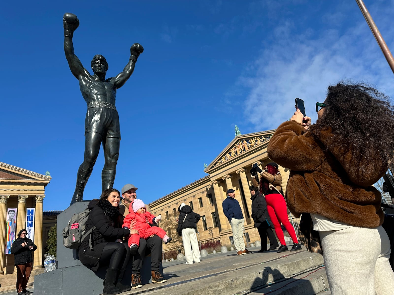 Visitors gather around the Rocky Statue and the “Rocky Steps” during RockyFest 2024 at the Philadelphia Museum of Art, Tuesday, Dec. 3, 2024, in Philadelphia. (AP Photo Tassanee Vejpongsa)