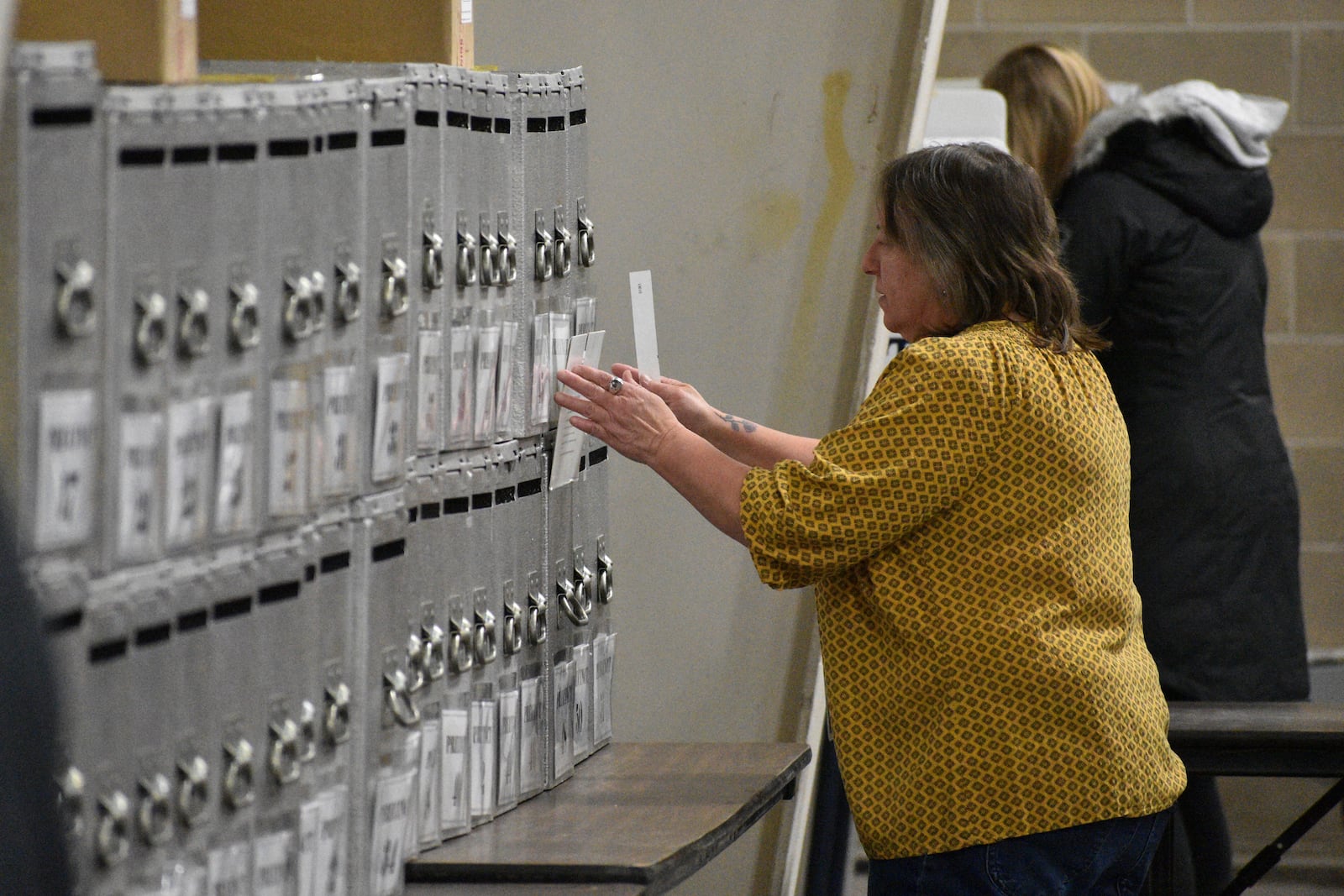 A Yellowstone County election worker places a ballot into a box at MetraPark on Election Day, Tuesday, Nov. 5, 2024, in Billings, Mont. (AP Photo/Matthew Brown)