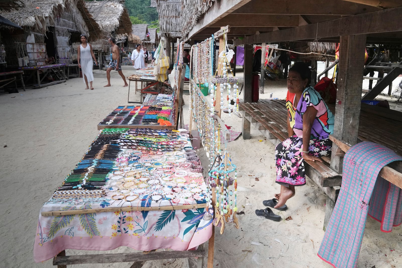 Bon Klathale wait for customers to sell souvenirs at Moken village at Surin Islands in Phang Nga Province, Thailand, Wednesday, Dec. 11, 2024. (AP Photo/Sakchai Lalit)