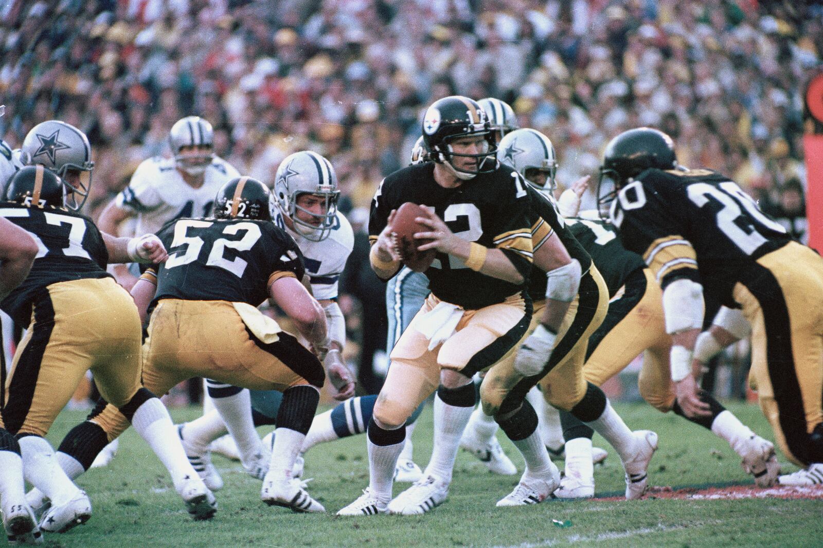 FILE - Pittsburgh Steelers quarterback Terry Bradshaw (12) turns around with the ball after the snap to hand the ball to an open receiver against the Dallas Cowboys in Super Bowl XIII action in Miami, Fla., Jan. 21, 1979. Steelers running back Rocky Blier (20) is at right. (AP Photo/File)