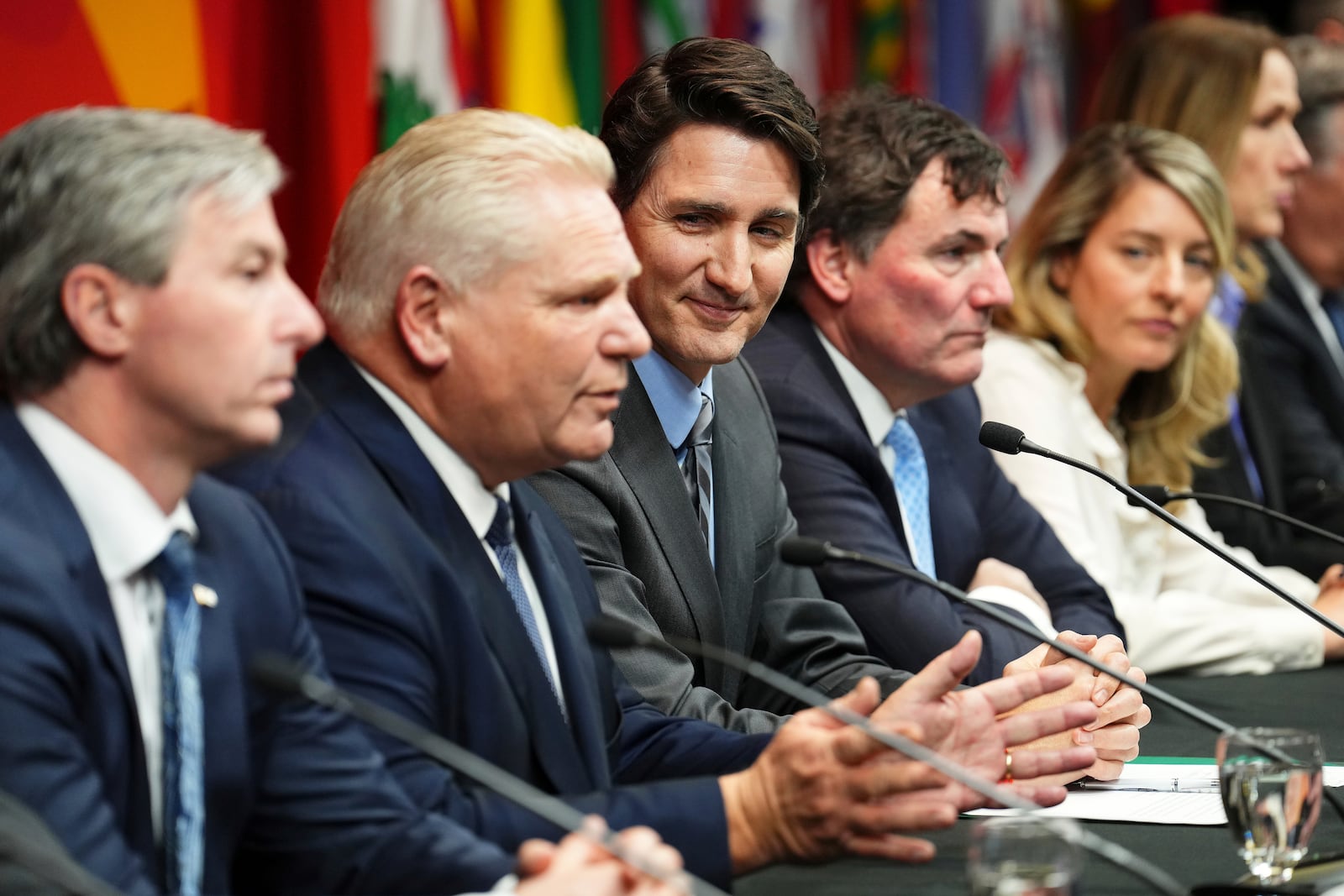 Canada's Prime Minister Justin Trudeau, center, looks on as Ontario Premier Doug Ford, second left, speaks at a press conference concluding a first ministers meeting, in Ottawa, Ontario, Wednesday, Jan. 15, 2025. (Sean Kilpatrick/The Canadian Press via AP)