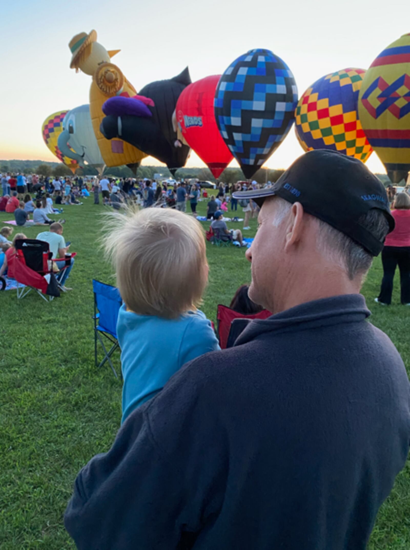 David Hiteshew and his grandson watch hot air balloons rise during The Ohio Challenge in Middletown. CONTRIBUTED