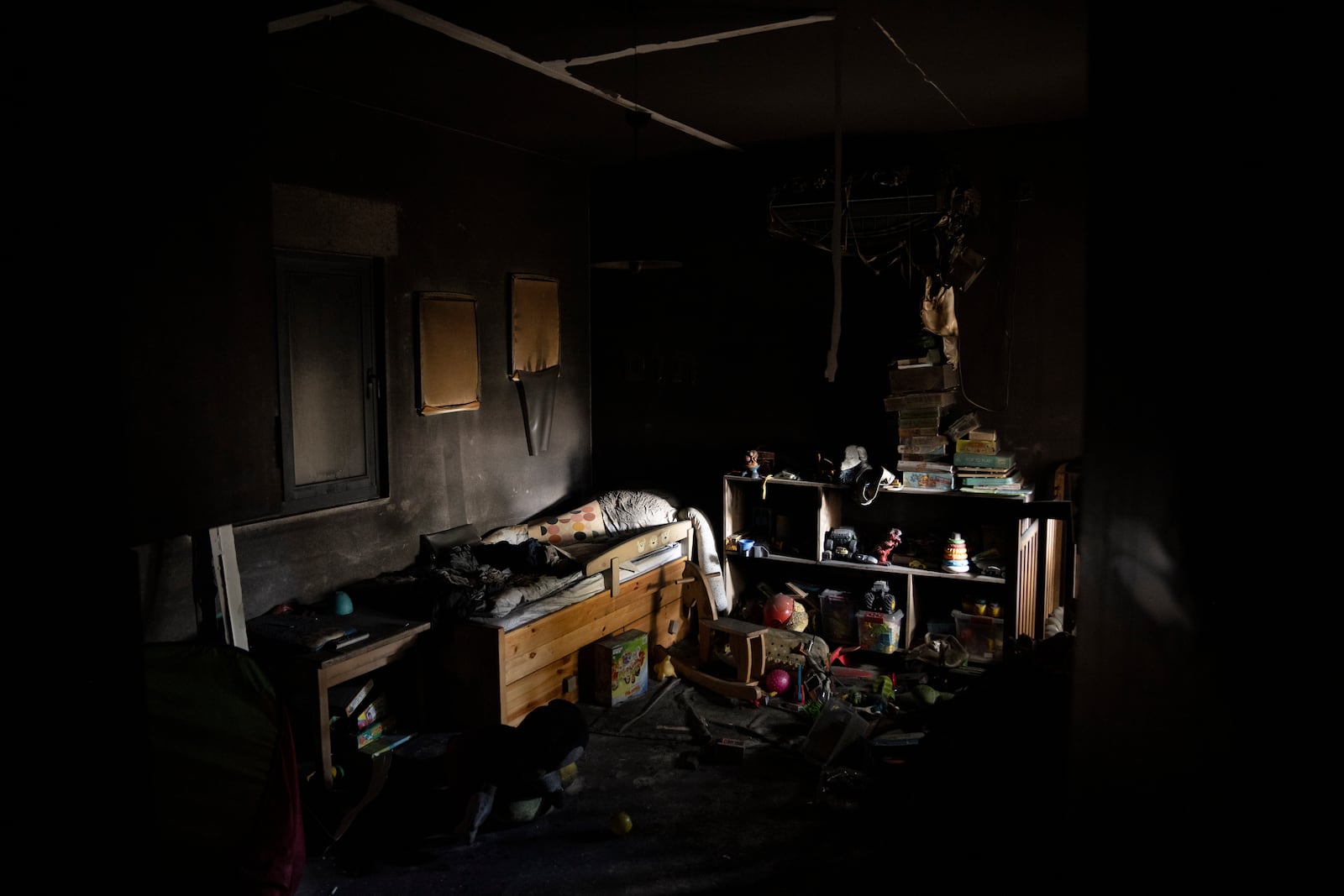 A bed and toys are seen in a bedroom of a house that was hit by a rocket fired from Lebanon, in the Kibbutz Manara, northern Israel, Thursday, Nov. 28, 2024. (AP Photo/Leo Correa)