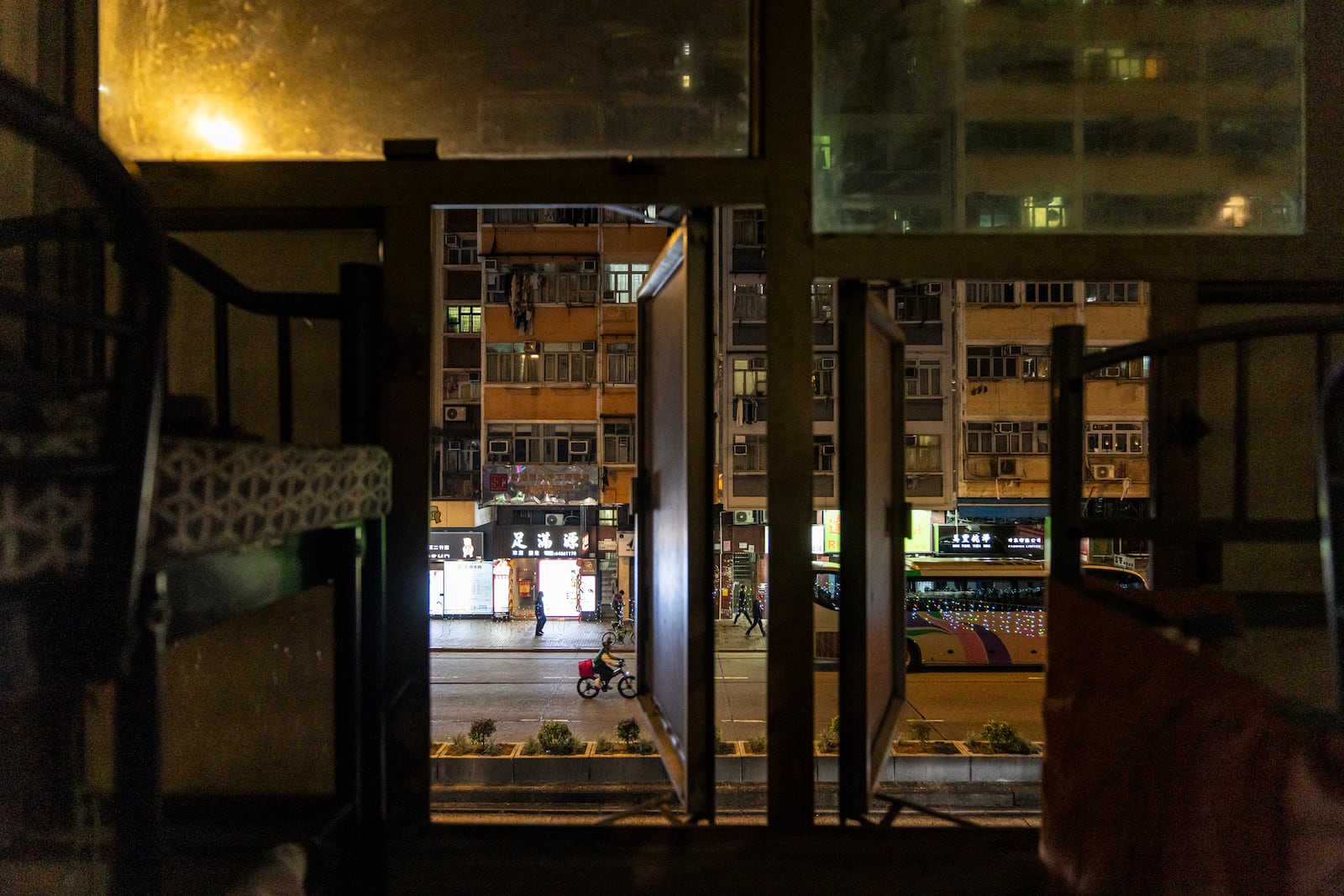 Residential buildings are seen through a window of a bed space in Sham Shui Po district of Hong Kong, on Feb. 6, 2025. (AP Photo/Chan Long Hei)