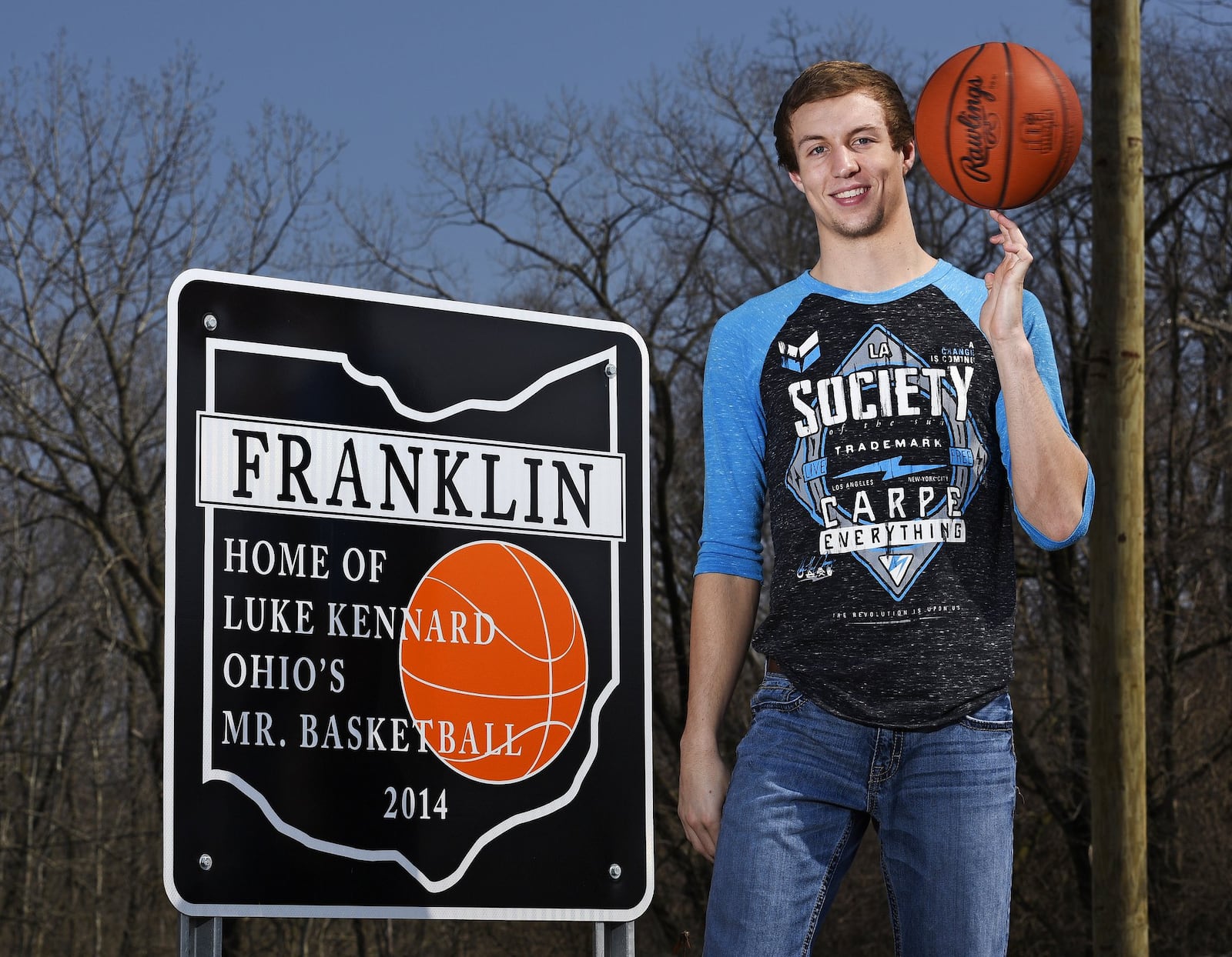 In this 2015 file photo, then-Franklin High School senior Luke Kennard stands next to one of the signs that were installed in Franklin honoring his Ohio Mr. Basketball honor. In the past few weeks, two of the five signs have been stolen forcing the city to take down the others. NICK GRAHAM/ STAFF