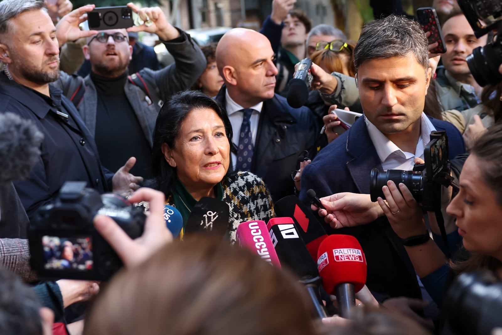 In this photo released by Georgian Presidential Press Office, Georgian President Salome Zourabichvili, center, speaks to the media after voting at a polling station during the parliamentary election in Tbilisi, Georgia, Saturday, Oct. 26, 2024. (Georgian Presidential Press Office via AP)