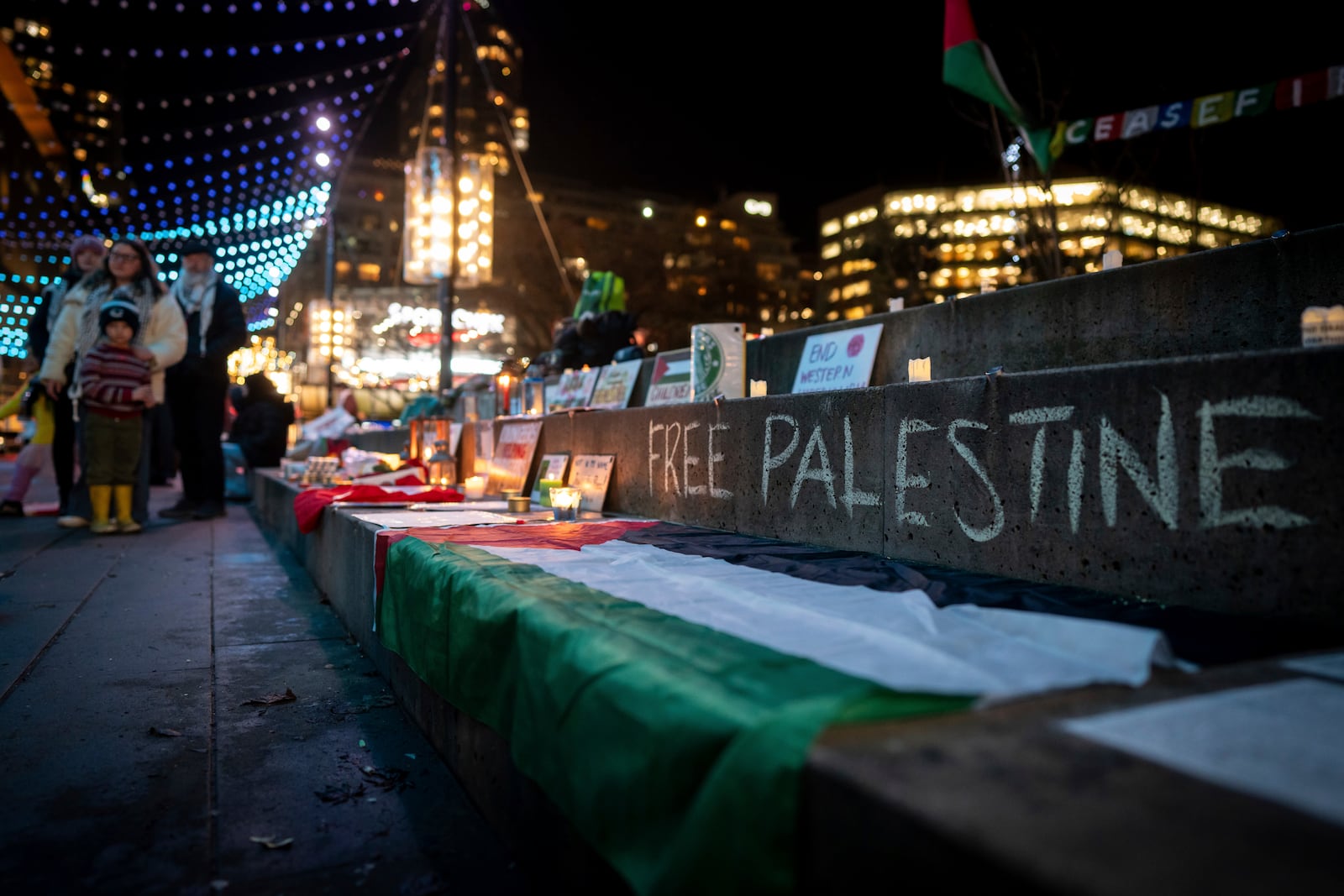 People gather to celebrate the Gaza ceasefire and hostage deal reached between Israel and Hamas in Vancouver, British Columbia, Wednesday, Jan. 15, 2025. (Ethan Cairns/The Canadian Press via AP)