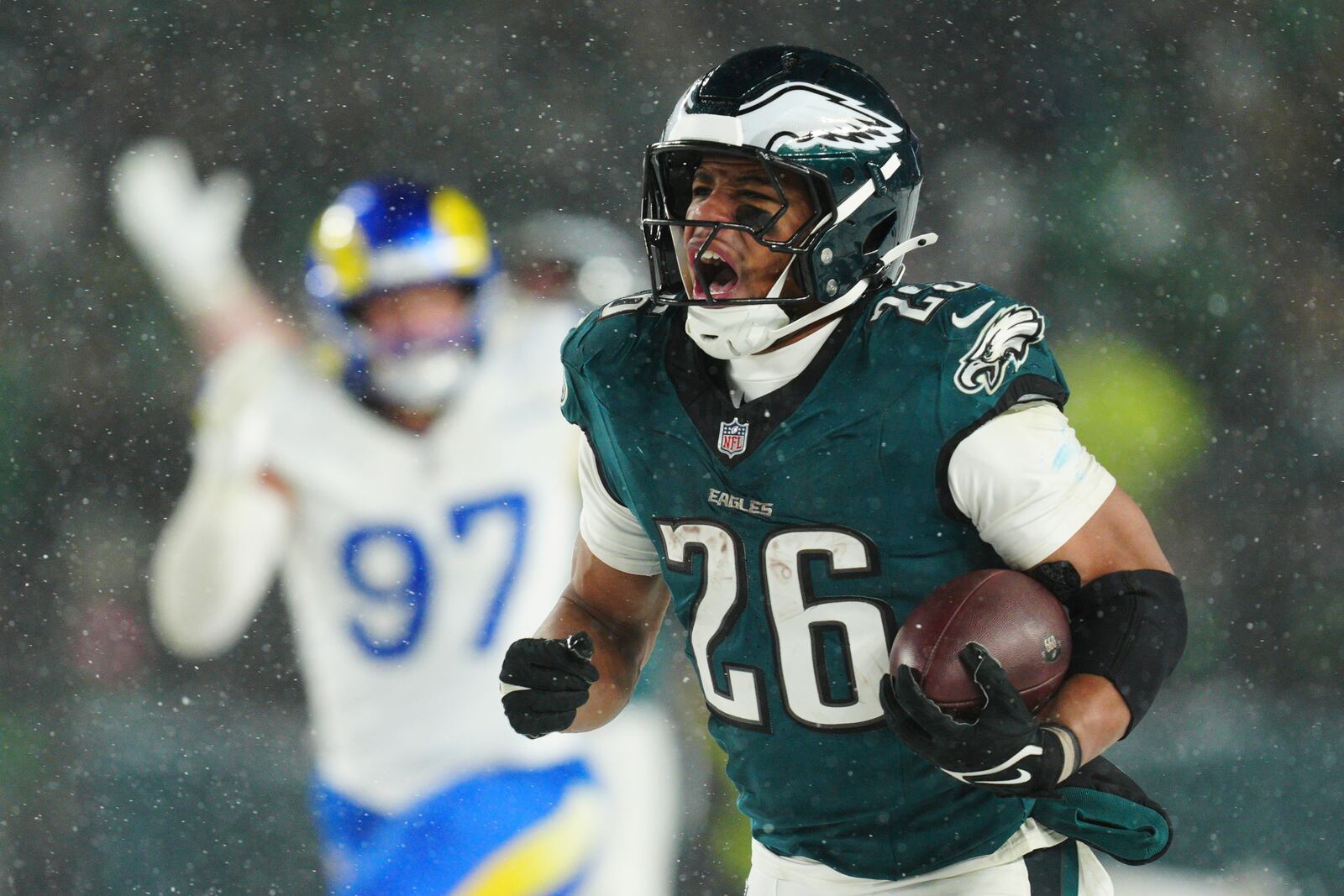 Philadelphia Eagles running back Saquon Barkley (26) runs the ball for a touchdown during the second half of an NFL football NFC divisional playoff game against the Los Angeles Rams on Sunday, Jan. 19, 2025, in Philadelphia. (AP Photo/Derik Hamilton)