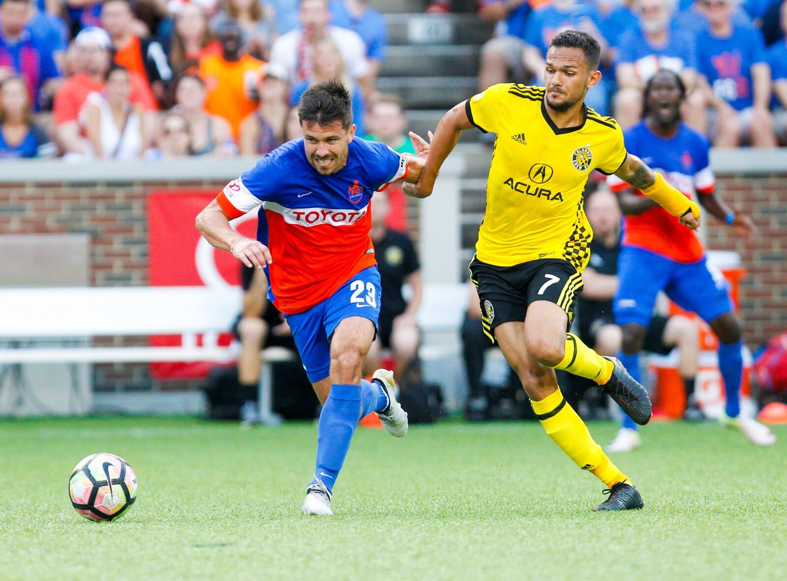 FC Cincinnati Andrew Weideman (23) battles Columbus Crew Artur midfielder (7) during their Open Cup match, held at Nippert Stadium on the campus of the University of Cincinnati, Wednesday, June 14, 2017. GREG LYNCH / STAFF