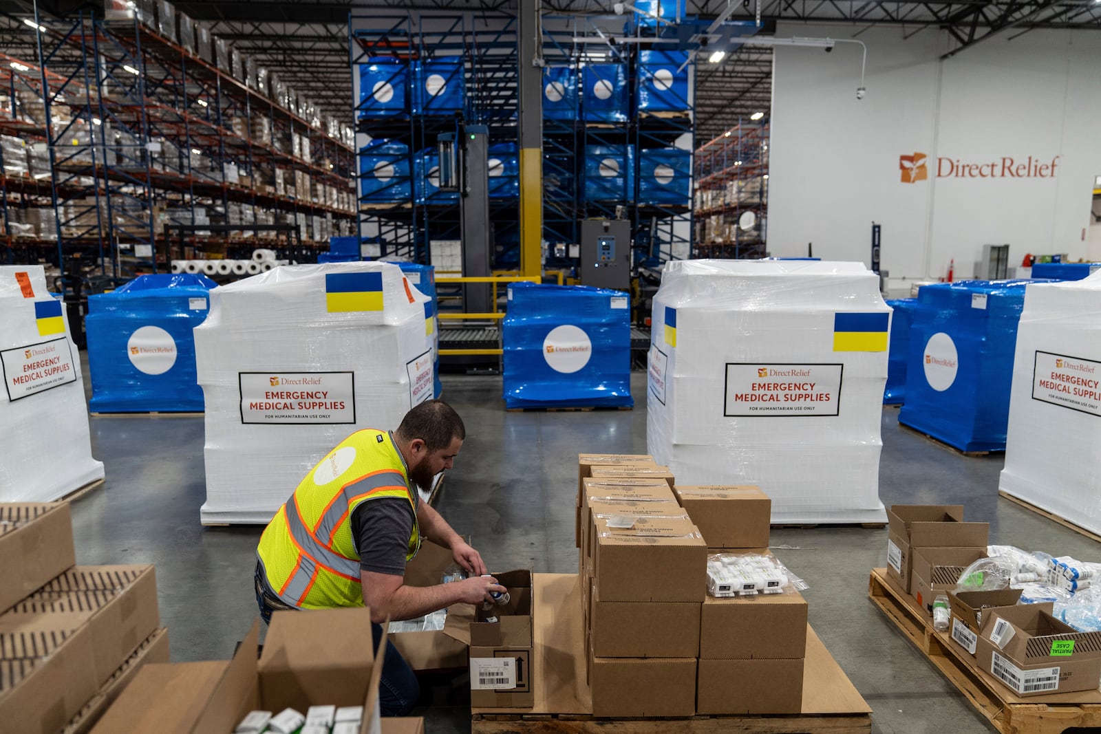 Bobby Contreras packs medicine into a box at Direct Relief's headquarters in Santa Barbara, Calif., Friday, Dec. 20, 2024. (AP Photo/Jae C. Hong)