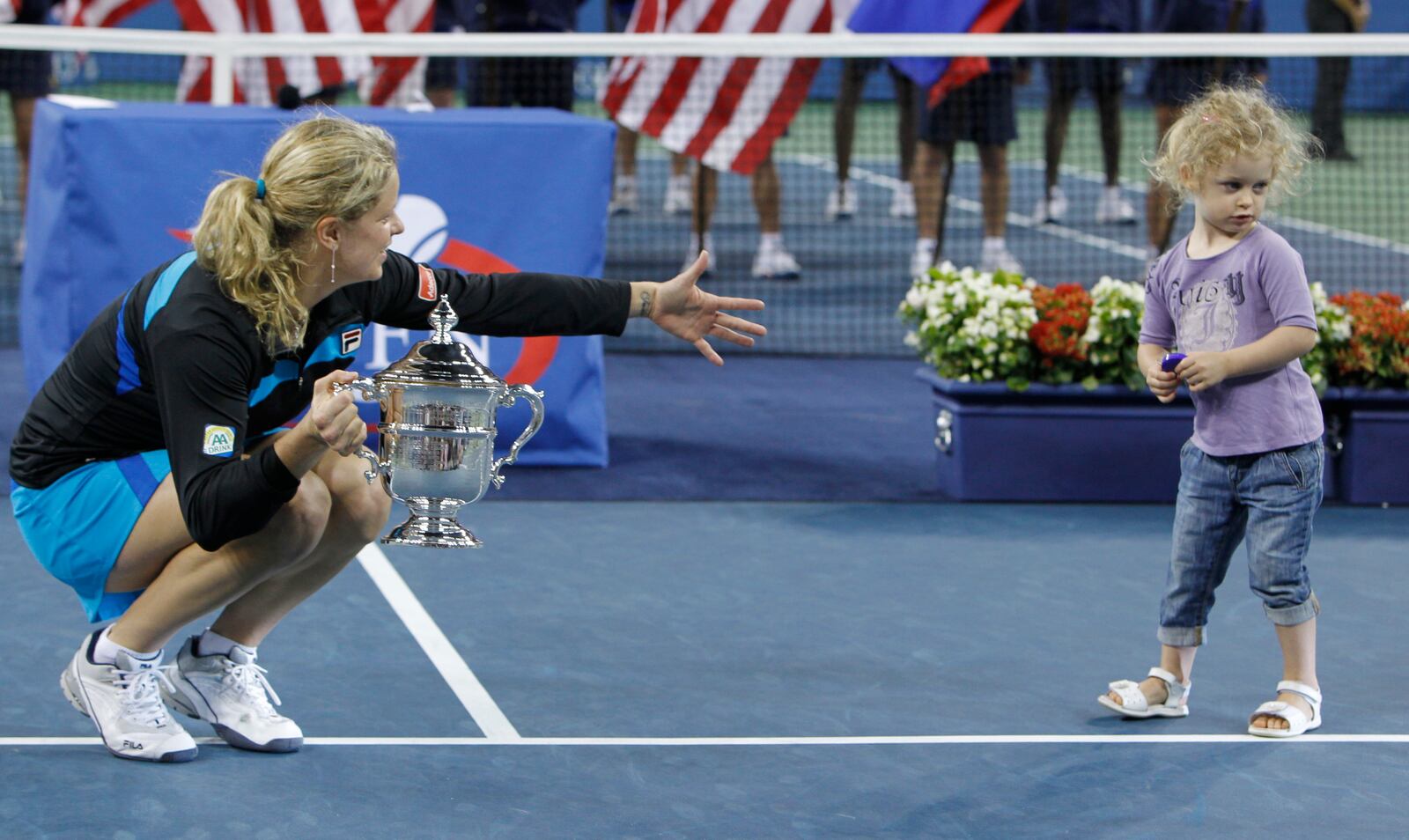 FILE - Kim Clijsters, of Belgium, holds the championship trophy for her daughter, Jada Ellie, after winning the finals at the U.S. Open tennis tournament in New York, Sept. 11, 2010. (AP Photo/Mark Humphrey, File)