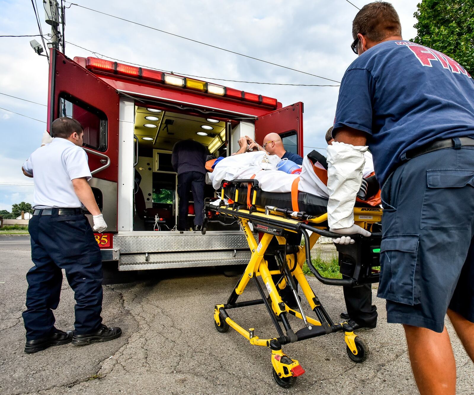 Middletown paramedics and police officers found a man unconscious, lying between two vehicles across the alley behind the Midd-Town Carry Out on Central Avenue Monday, June 26. Paramedics first tried to start an IV, the fastest and most effective way to push Narcan into the man’s system. When that failed, Narcan was administered through the man’s nose. Then a second IV was started. The entire time, paramedics bagged the gentleman until his oxygen level returned to normal. Two doses of Narcan, twice the normal amount, were used to revive the man, who was transported to Atrium Medical Center. NICK GRAHAM/STAFF