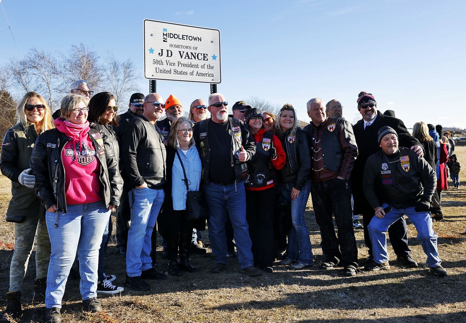 Beverly Aikins, mother of Vice President JD Vance, stands with a group from Bikers for Trump during a ribbon cutting of the newly installed signs recognizing Vance Saturday, Feb. 1, 2025 in his hometown of Middletown. NICK GRAHAM/STAFF