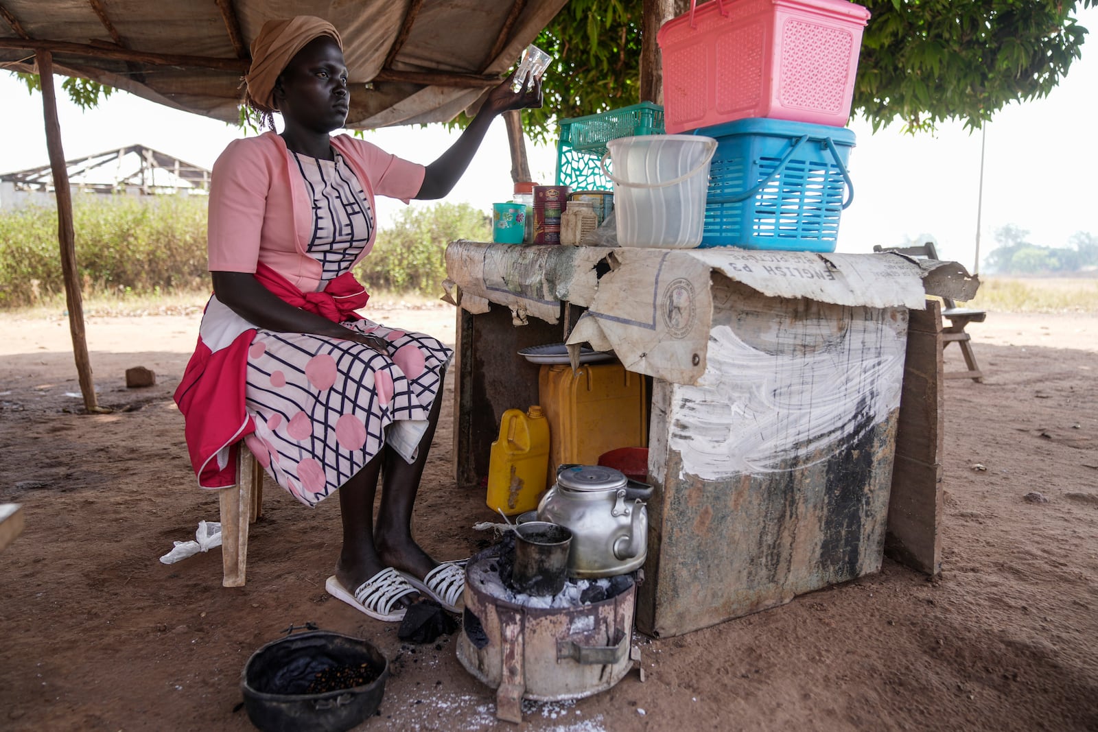 A food vendor prepares a coffee in Yambio, South Sudan Monday, Feb. 17, 2025. (AP Photo/Brian Inganga)