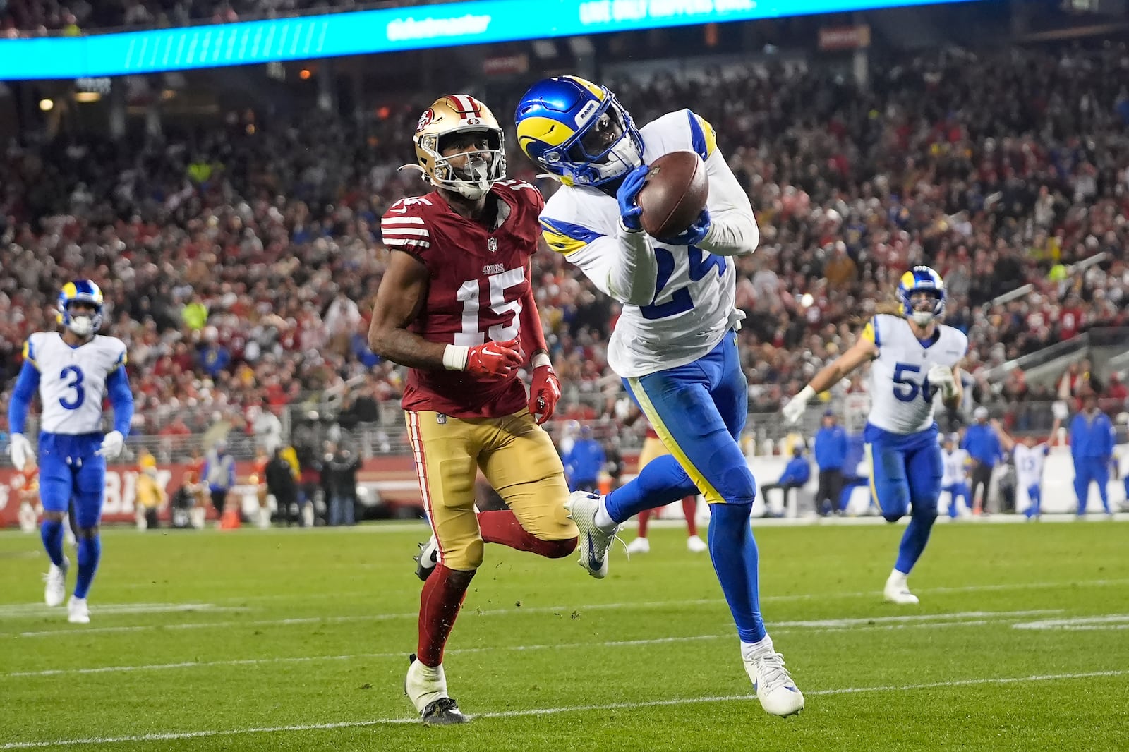 Los Angeles Rams cornerback Darious Williams (24) intercepts a pass in front of San Francisco 49ers wide receiver Jauan Jennings (15) during the second half of an NFL football game in Santa Clara, Calif., Thursday, Dec. 12, 2024. (AP Photo/Godofredo A. Vásquez)