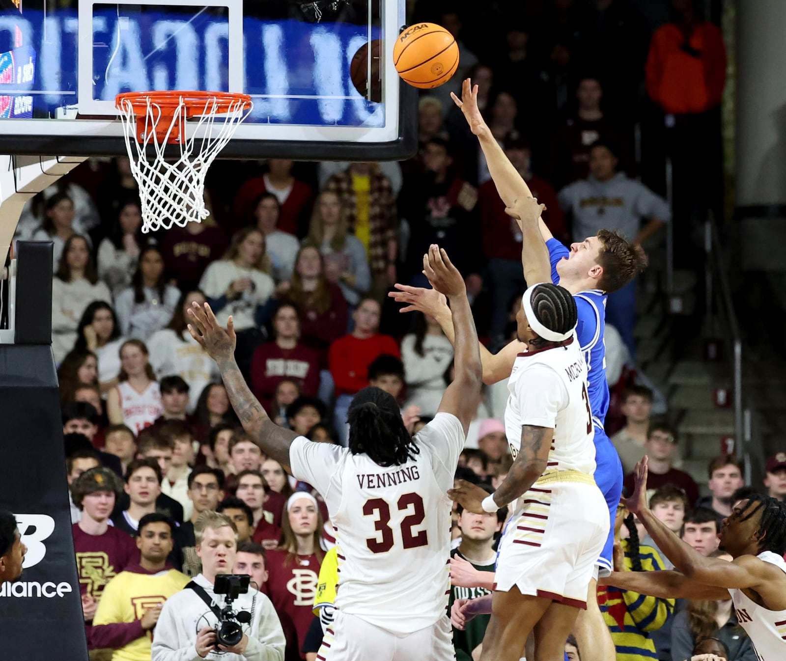 Duke guard Cooper Flagg, upper right, scores against Boston College forward Chad Venning (32) and guard Roger McFarlane (3) during the second half of an NCAA college basketball game Saturday, Jan. 18, 2025, in Boston. (AP Photo/Mark Stockwell)