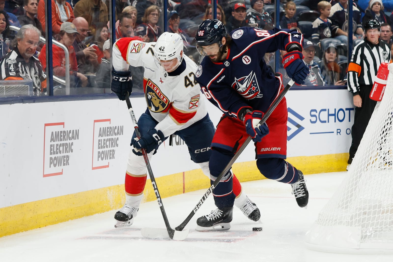 Florida Panthers' Gustav Forsling, left, and Columbus Blue Jackets' Kirill Marchenko fight for the puck during the second period of an NHL hockey game Tuesday, Oct. 15, 2024, in Columbus, Ohio. (AP Photo/Jay LaPrete)