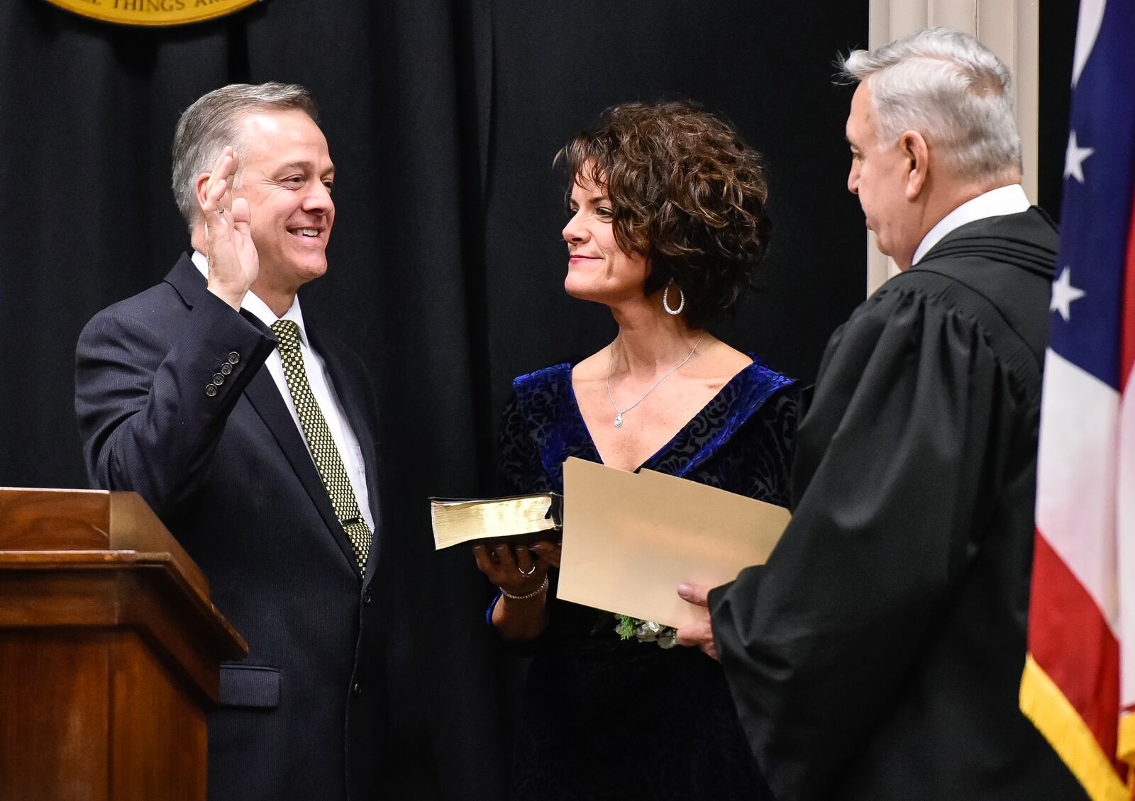 James E. Sherron, left, accompanied by his wife, Melanie, is sworn in as Middletown Municipal Court Judge by Butler County Common Pleas Court Judge Noah Powers II during a ceremony Monday, Dec. 18 at Miami University Middletown campus. NICK GRAHAM/STAFF