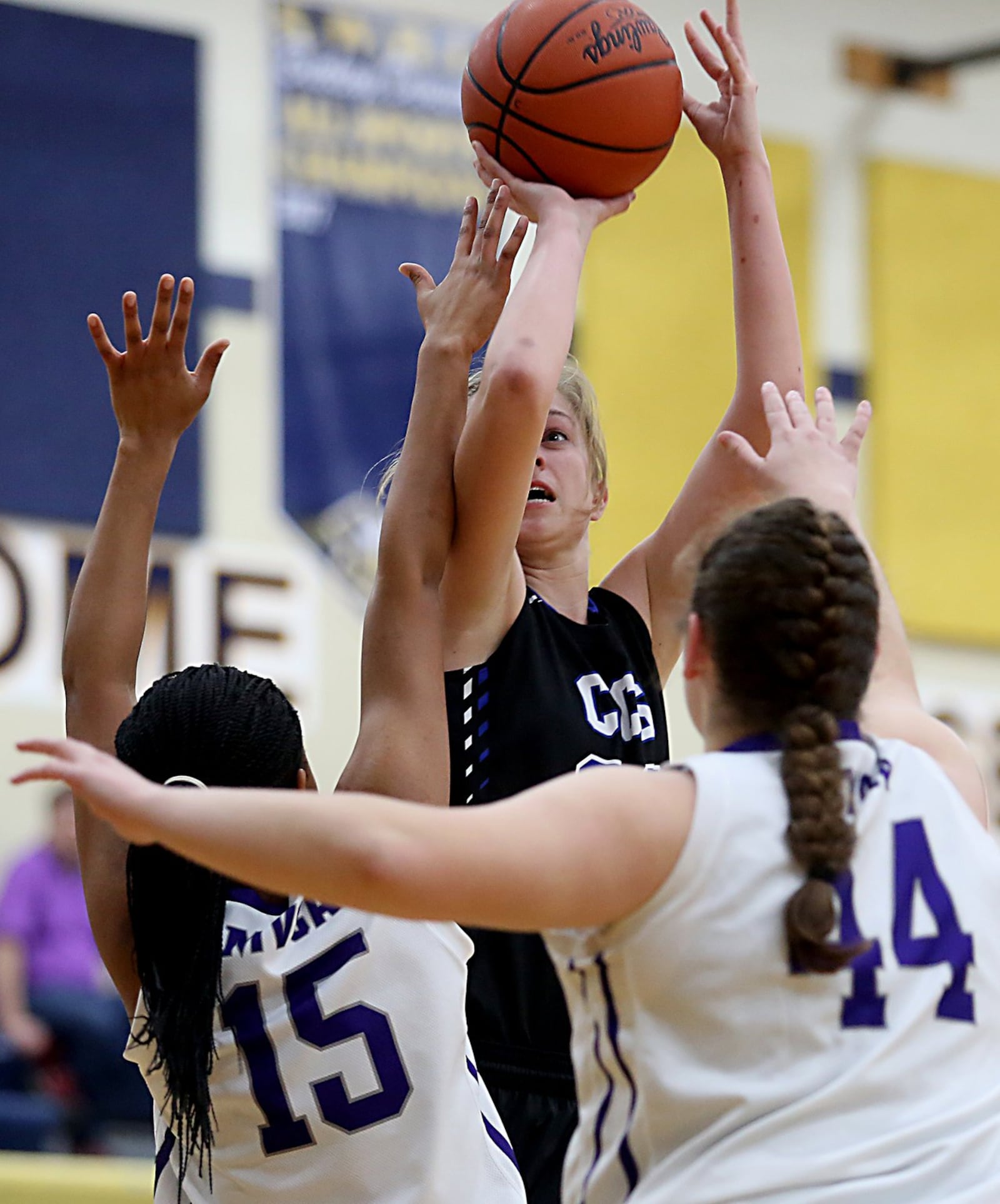 Cincinnati Christian center Grace Edmonston shoots over Miami Valley Christian Academy’s Michelle Lee (15) and Dawsyn Vilardo (44) during their Division IV sectional game at Monroe on Tuesday night. CONTRIBUTED PHOTO BY E.L. HUBBARD