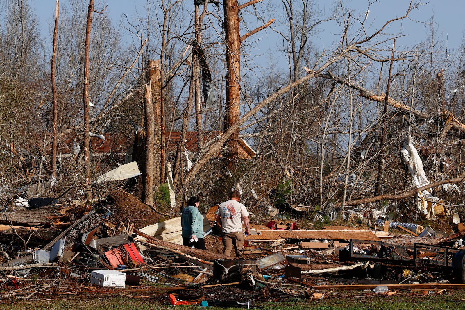 Residents look for personal belongings in the damage after a tornado passed through where two people lost their lives, Sunday, March 16, 2025, in Plantersville, Ala. (AP Photo/Butch Dill)