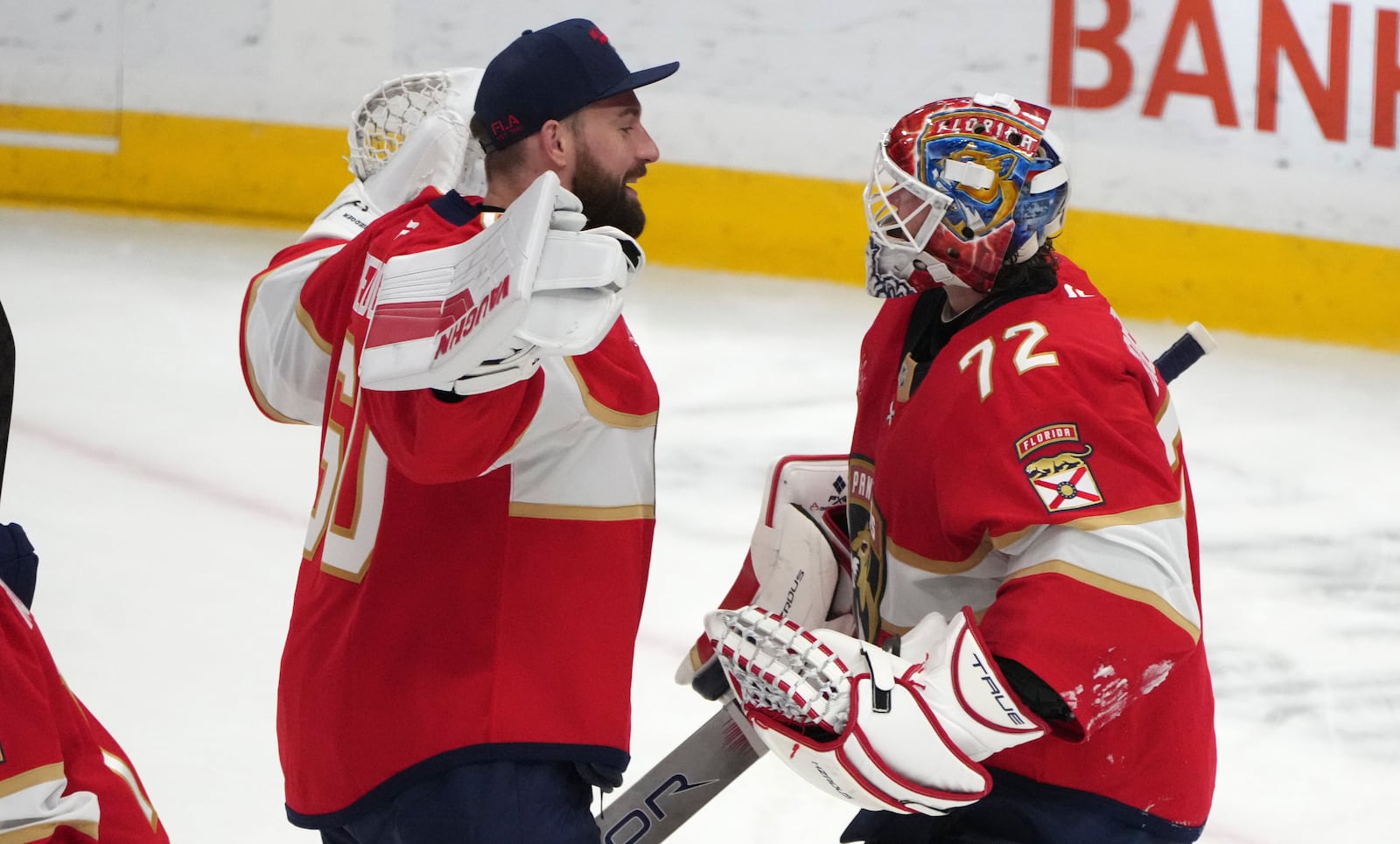 Florida Panthers goaltender Chris Driedger (60) congratulates goaltender Sergei Bobrovsky (72) after an NHL hockey game against the Tampa Bay Lightning Monday, March 3, 2025, in Sunrise, Fla. (AP Photo/Lynne Sladky)