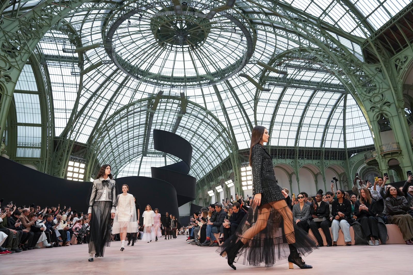 Vittoria Ceretti leads other models as they wear creations as part of the Chanel Fall/Winter 2025-2026 Womenswear collection presented Tuesday, March 11, 2025. in Paris. (Photo by Scott A Garfitt/Invision/AP)