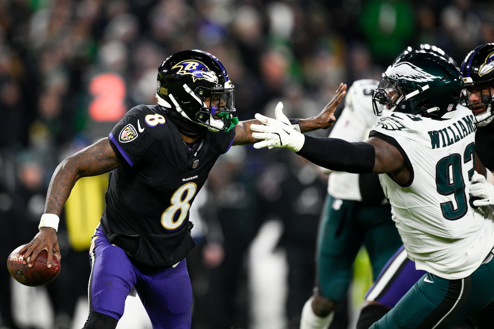 Baltimore Ravens quarterback Lamar Jackson (8) is pressured by Philadelphia Eagles defensive tackle Milton Williams (93) during the second half of an NFL football game, Sunday, Dec. 1, 2024, in Baltimore. (AP Photo/Nick Wass)