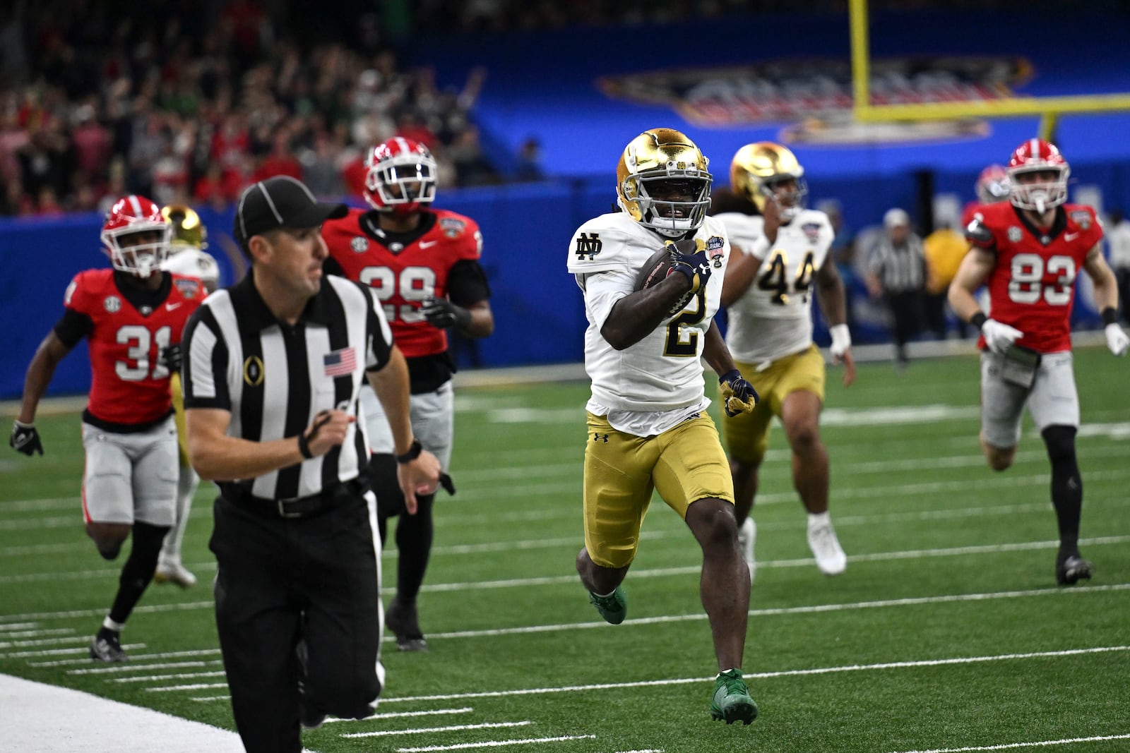 Notre Dame's Jayden Harrison (2) returns a kickoff 98 yards for a touchdown during the second half against Georgia in the quarterfinals of a College Football Playoff, Thursday, Jan. 2, 2025, in New Orleans. (AP Photo/Matthew Hinton)