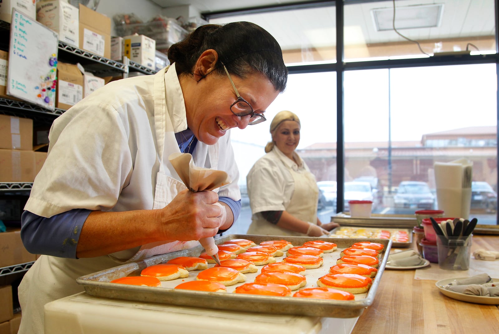 Laura Enzbrenner, the founder of Laura's Cookies which are sold at Dorothy Lane Market, decorates cookies for the Thanksgiving holiday. Enzbrenner said she would make 10,000 cookies this year during the week of Thanksgiving. LISA POWELL / STAFF