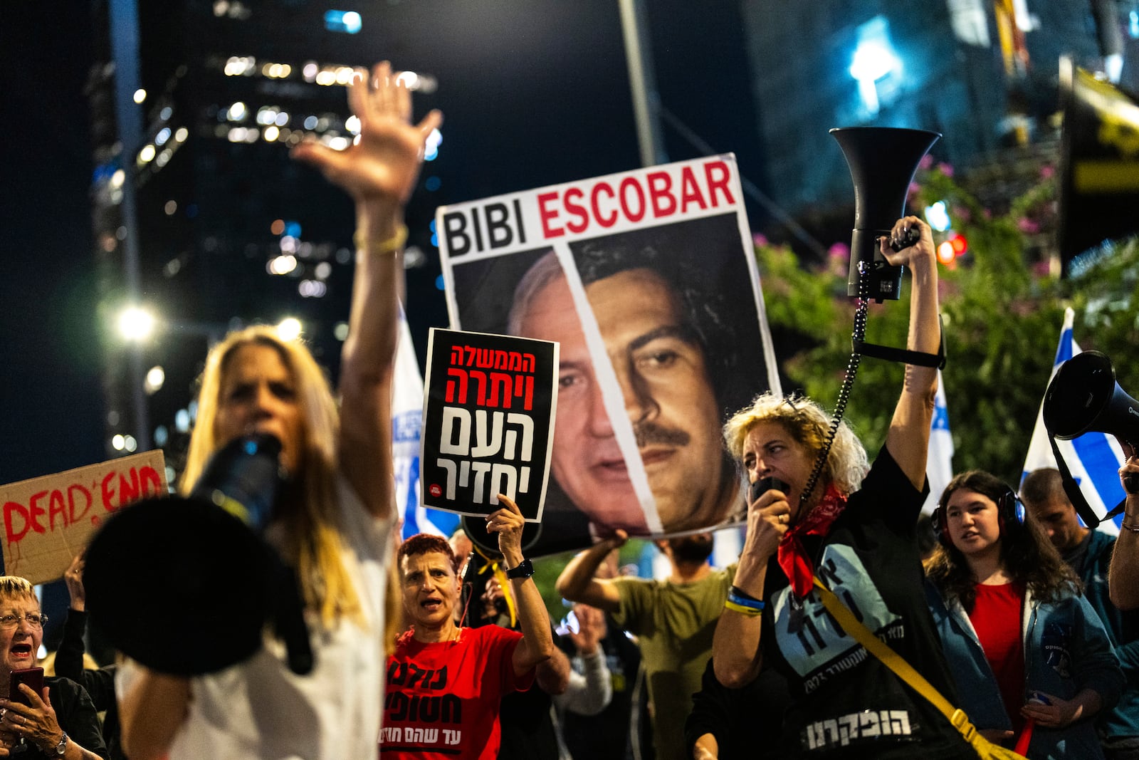 People shout slogans during a protest against Prime Minister Benjamin Netanyahu's government and call for the release of hostages held in the Gaza Strip by the Hamas militant group, in Tel Aviv, Israel, Saturday, Nov. 16, 2024. (AP Photo/Francisco Seco)