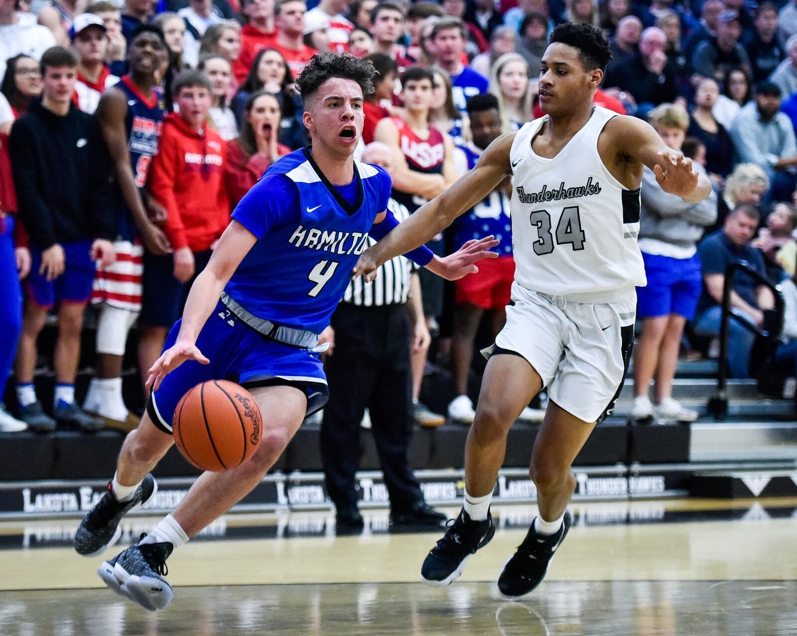 Hamilton’s Jayden Robinson drives around Lakota East’s Nate Johnson during Friday night’s game at East. Hamilton won 65-62. NICK GRAHAM/STAFF