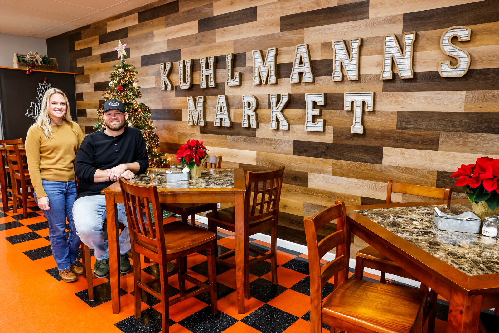 Allen Kuhlmann, with wife Christine, sits inside their shop at Kuhlmann's Fine Meats & Market on Cincinnati Columbus Road in West Chester Township. The building was formerly Luigi's Olde World Market before Kuhlmann purchased it and changed the name. NICK GRAHAM/STAFF