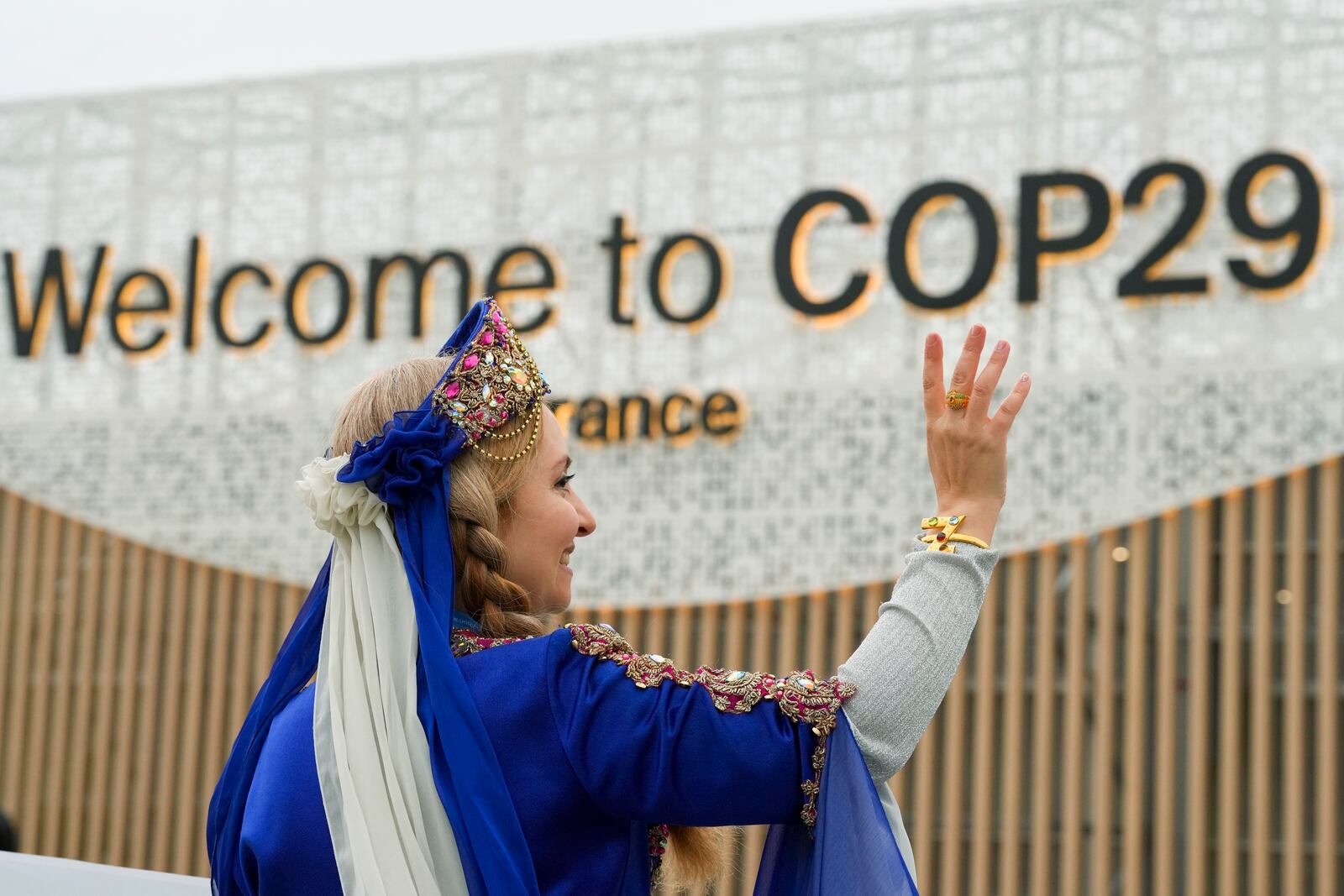 A women demonstrates with a sign on veganism at the COP29 U.N. Climate Summit, Tuesday, Nov. 12, 2024, in Baku, Azerbaijan. (AP Photo/Peter Dejong)