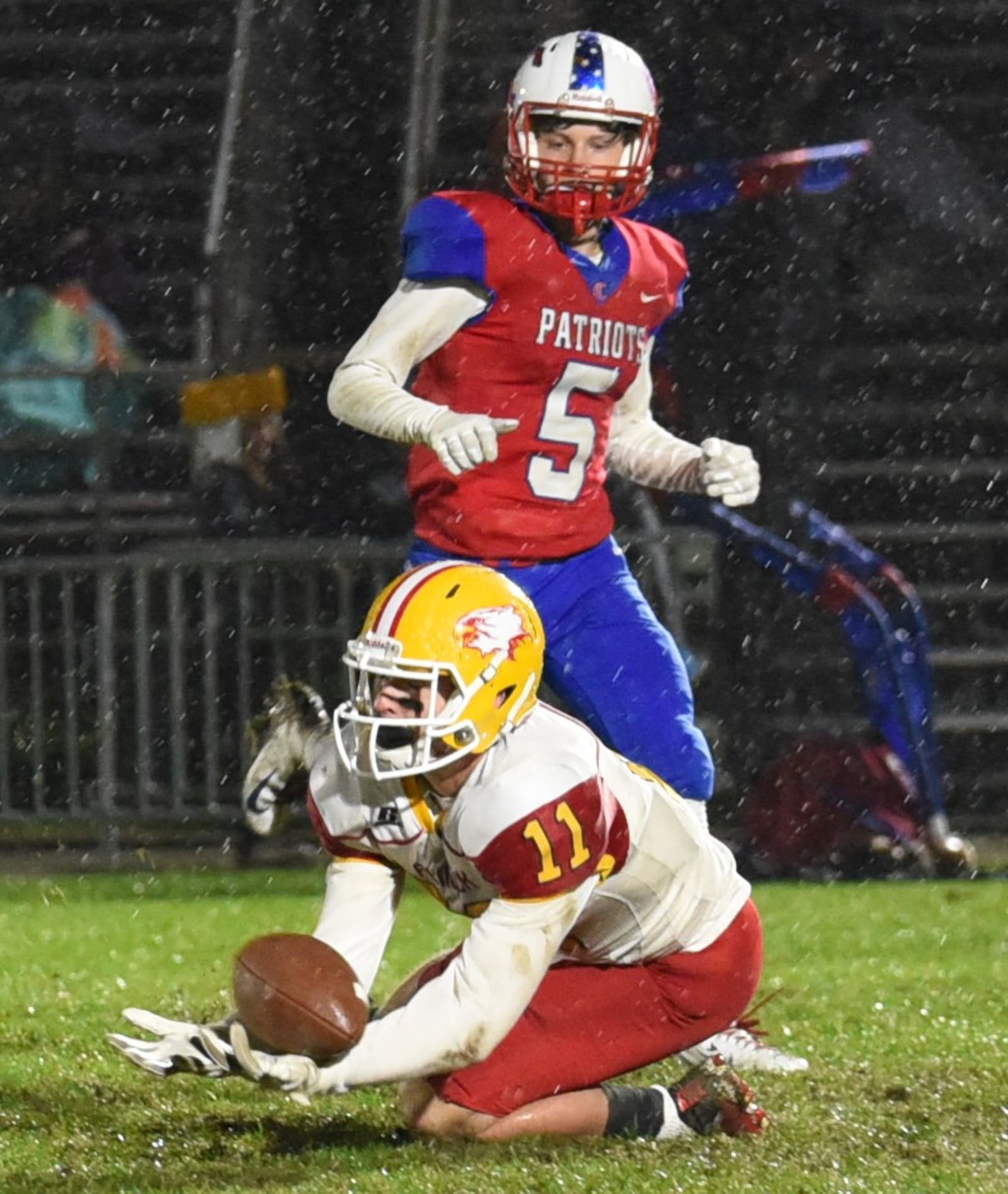 Fenwick’s Thomas Vogelsang (11) goes to the ground for a catch in front of Carroll’s Will Severt during Friday night’s game in Riverside. The visiting Falcons took a 42-41 win. CONTRIBUTED PHOTO BY ANGIE MOHRHAUS