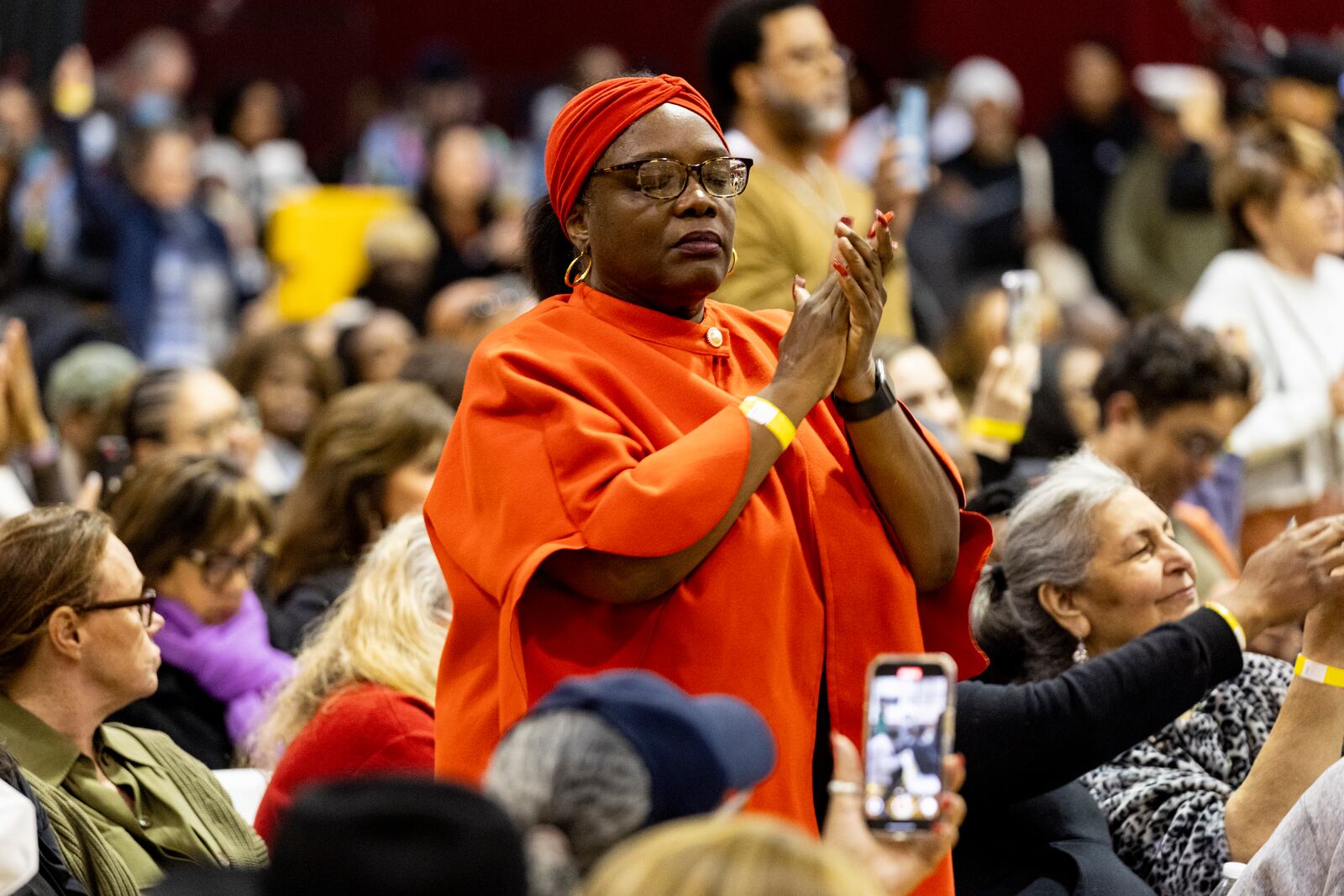 A member of the audience reacts as people impacted by the Eaton Fire attend an event at the gymnasium of Pasadena City College where The Change Reaction will be handing out about 1,000 checks of between $2,500-$5,000, in Pasadena, Tuesday, Jan. 28, 2025 in Pasadena, Calif. (AP Photo/Etienne Laurent)