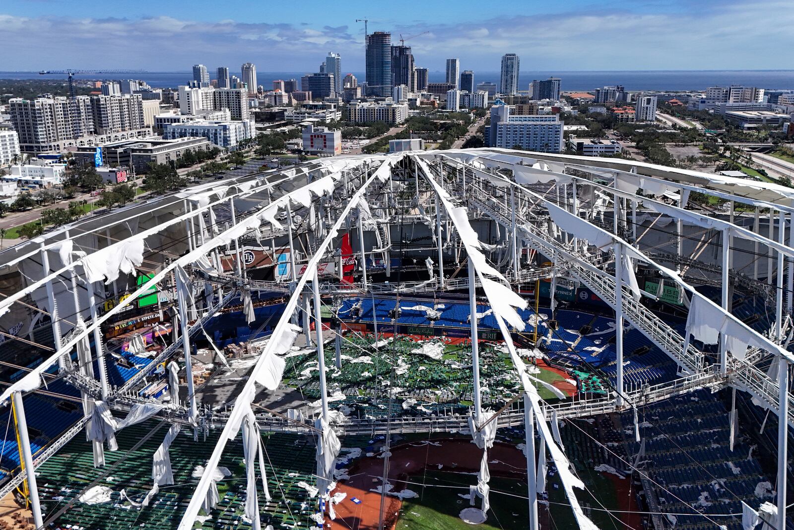 The roof of the Tropicana Field is damaged the morning after Hurricane Milton hit the region, Thursday, Oct. 10, 2024, in St. Petersburg, Fla. (AP Photo/Mike Carlson)