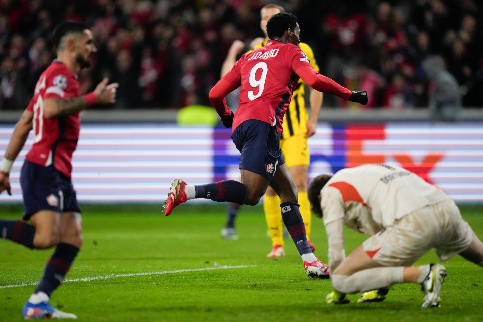 Lille's Jonathan David celebrates after scoring during the Champions League round of 16 second leg soccer match between Lille and Borussia Dortmund in Villeneuve-d'Ascq , Wednesday, March 12, 2025. (AP Photo/Michel Euler)