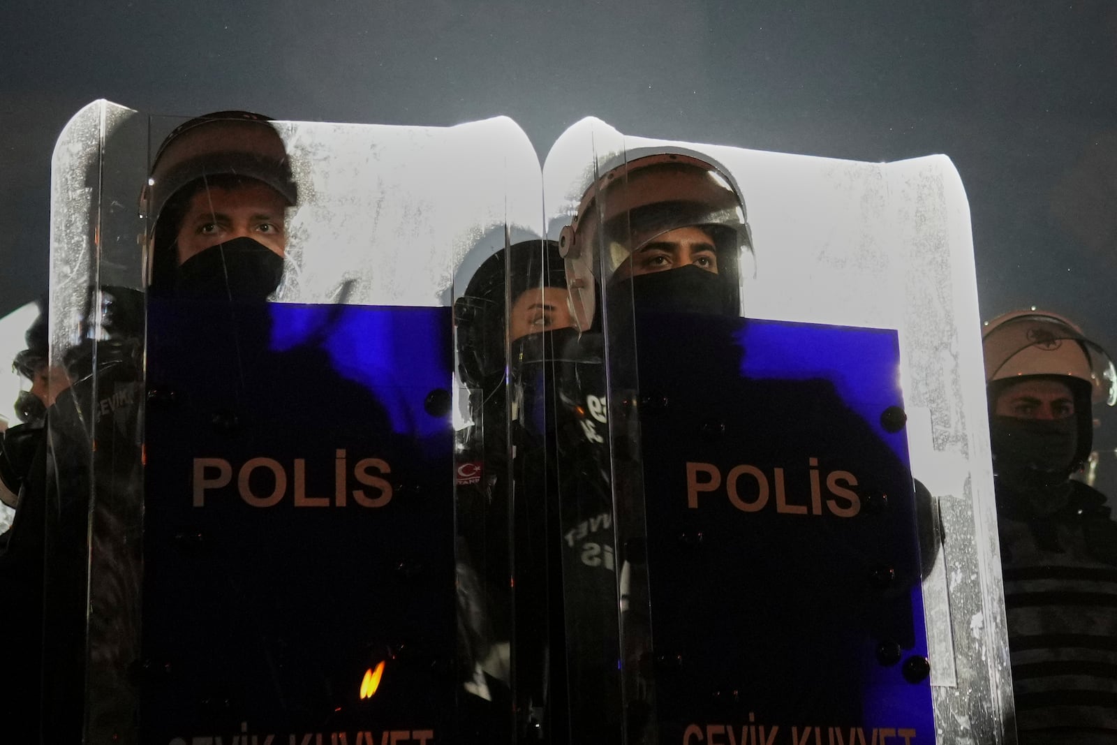 Riot police stand guard during a protest against the arrest of Istanbul's Mayor Ekrem Imamoglu, in Istanbul, Turkey, Saturday, March 22, 2025. (AP Photo/Francisco Seco)