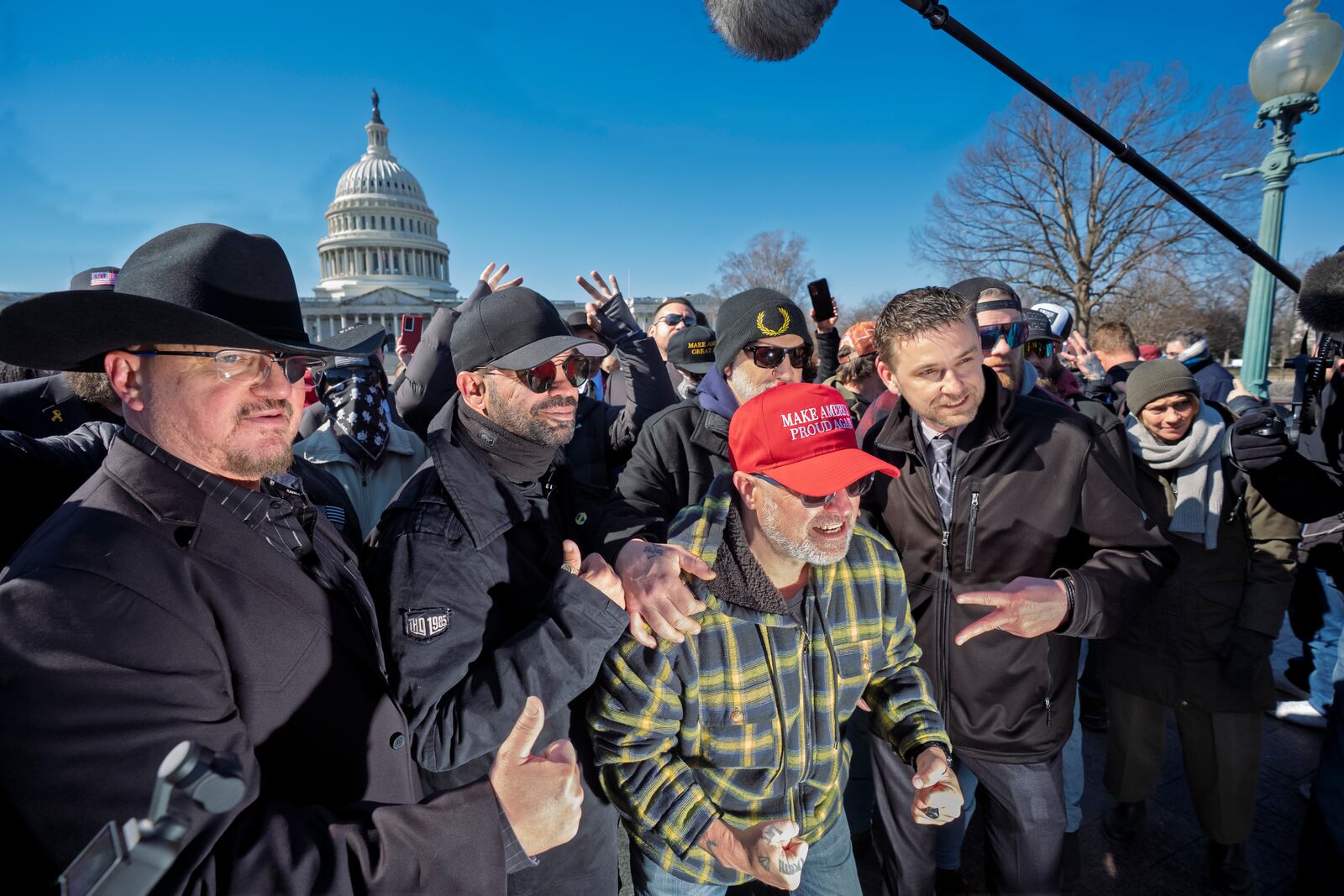 Oath Keepers founder Stewart Rhodes, from left, former Proud Boys leader Enrique Tarrio, Joseph Biggs and Zachary Rehl pose at a news conference at the U.S. Capitol in Washington, Friday, Feb. 21, 2025. (AP Photo/J. Scott Applewhite)