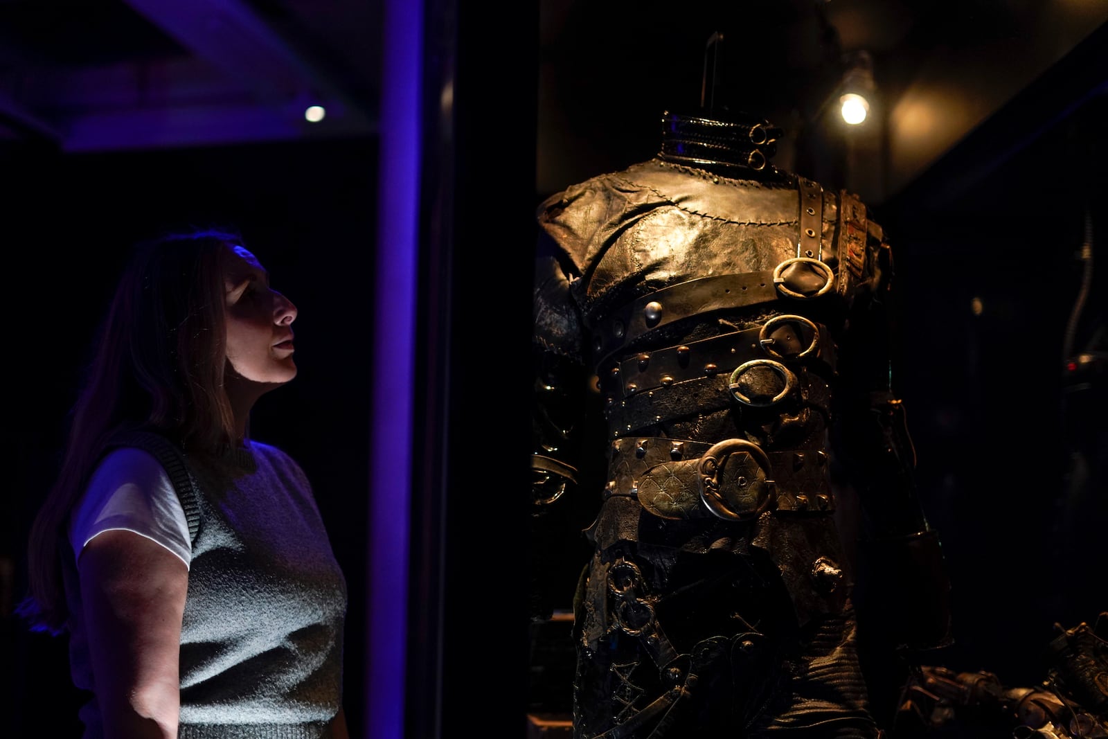 A member of staff poses next to a creation part of The World of Tim Burton exhibition at the Design Museum, in London, Monday, Oct. 21, 2024. The major exhibition sees Tim Burton's personal archives on display for the first time, featuring 600 items from his nearly fifty years long career. (AP Photo/Alberto Pezzali)