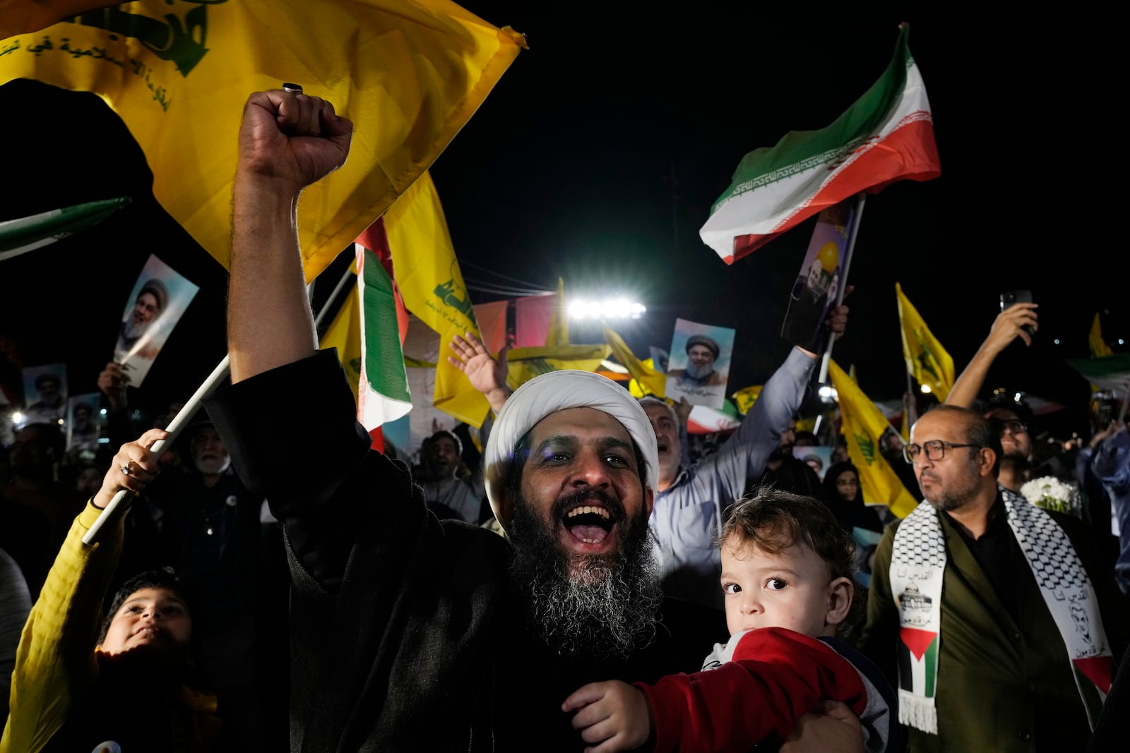 A cleric clenches his fist as he celebrates Iran's missile strike against Israel in an anti-Israeli gathering at Felestin (Palestine) Sq. in Tehran, Iran, Tuesday, Oct. 1, 2024. (AP Photo/Vahid Salemi)